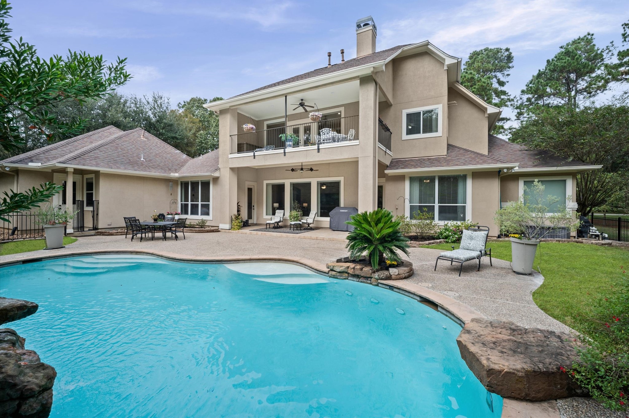 Beautiful backyard retreat with sparkling pool and covered patio