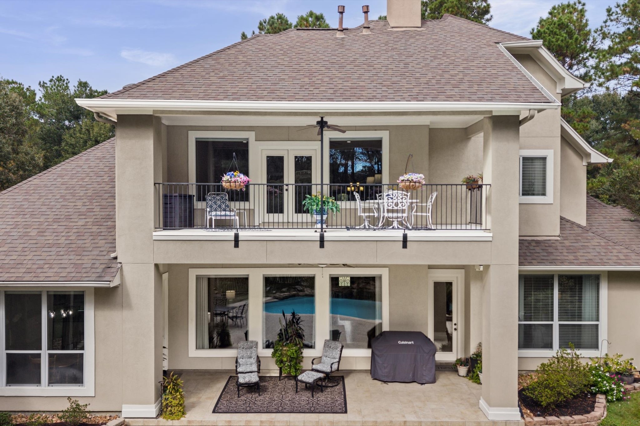 Rear elevation featuring two levels of covered outdoor living