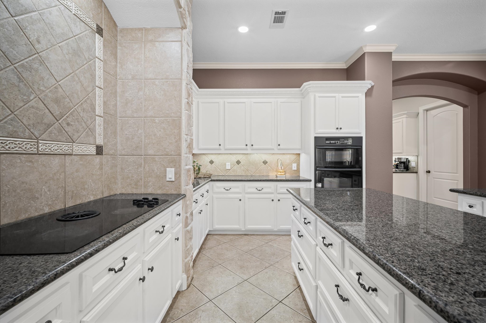 Additional view of the kitchen showcasing the expansive workspace and custom finishes