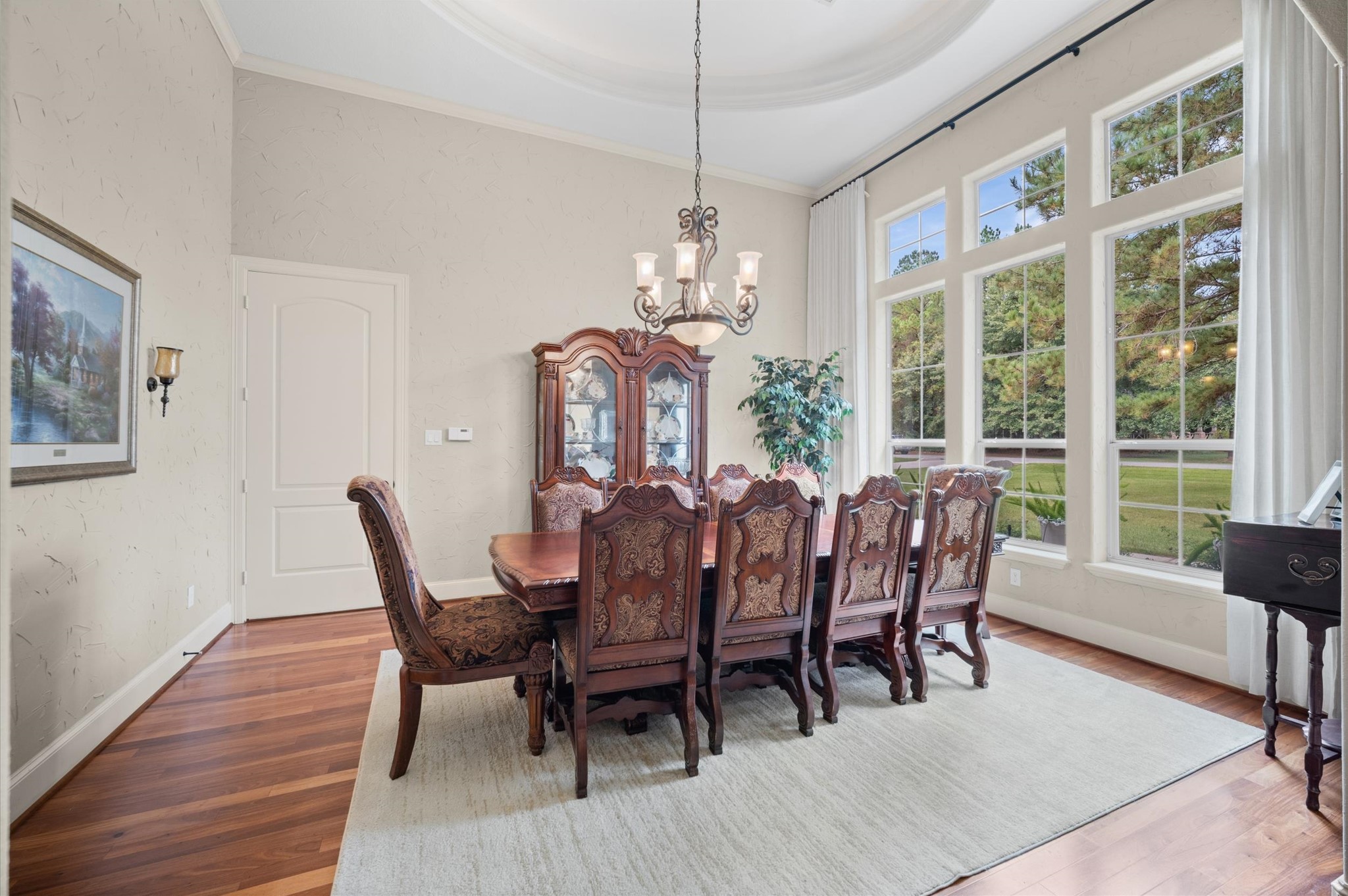 Elegant formal dining room with tile flooring and views of the backyard