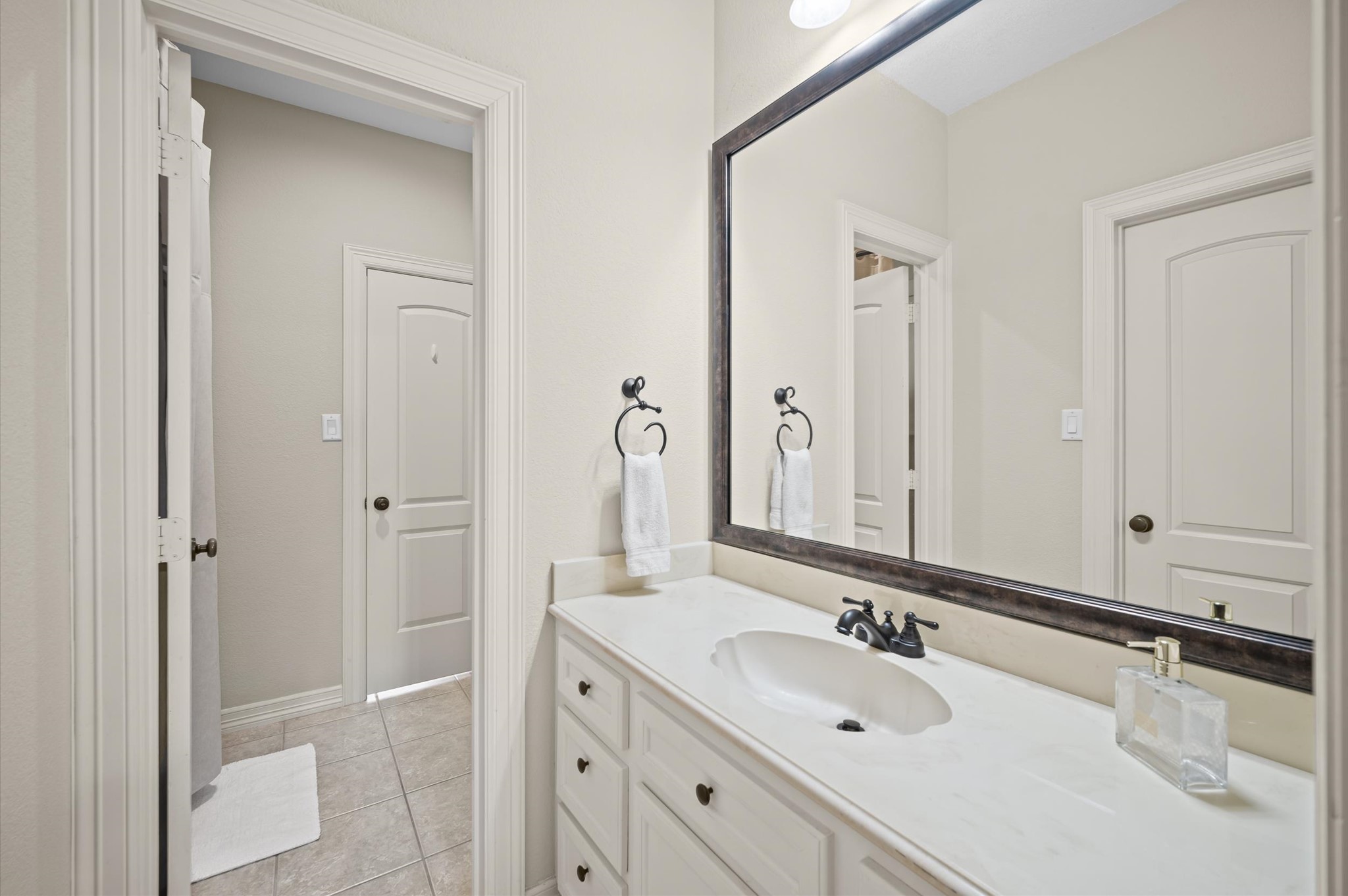 Upstairs full Bathroom featuring an extended vanity and generous counter space