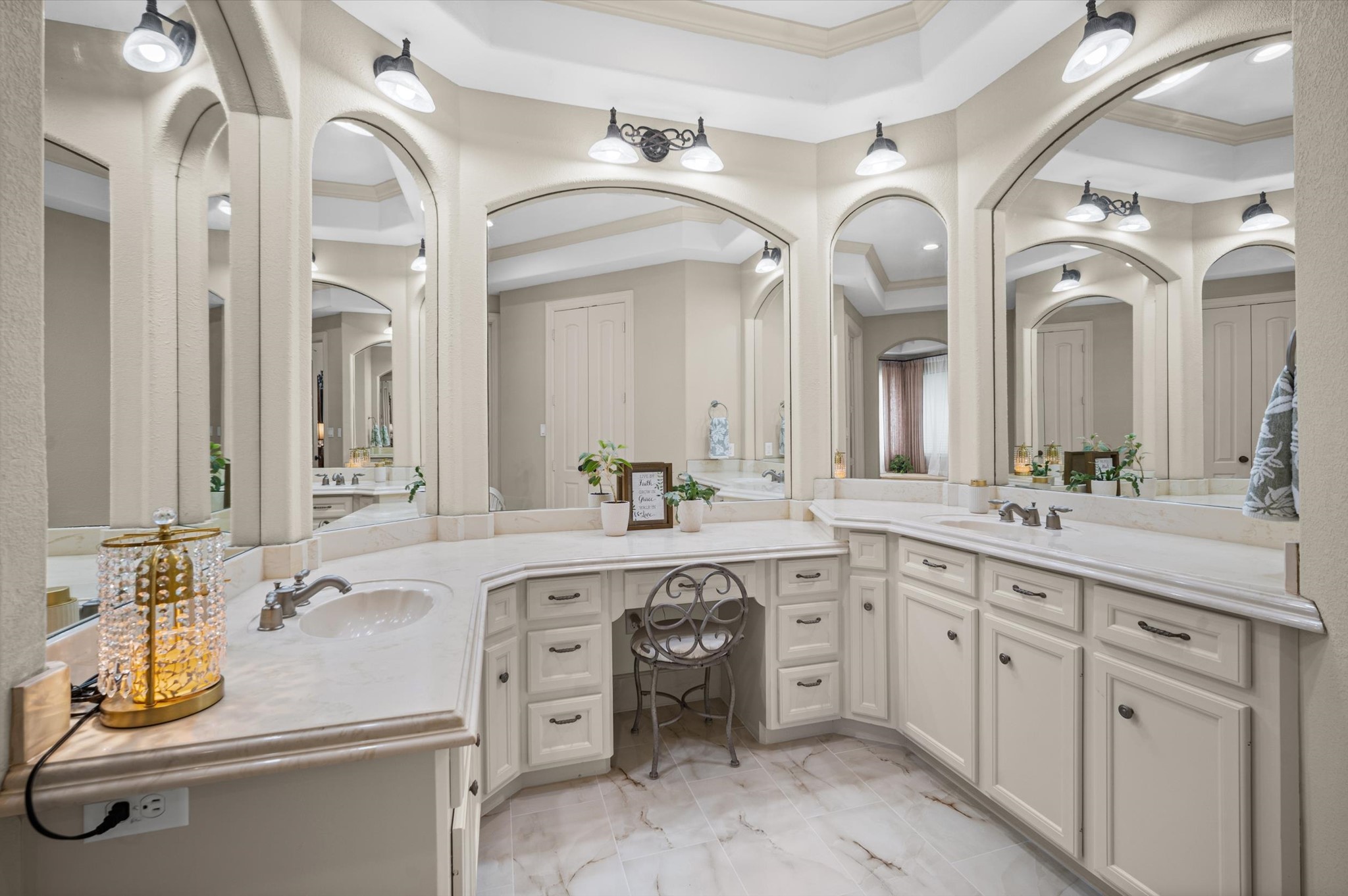 Luxurious primary bath with dual vanities and elegant architectural details