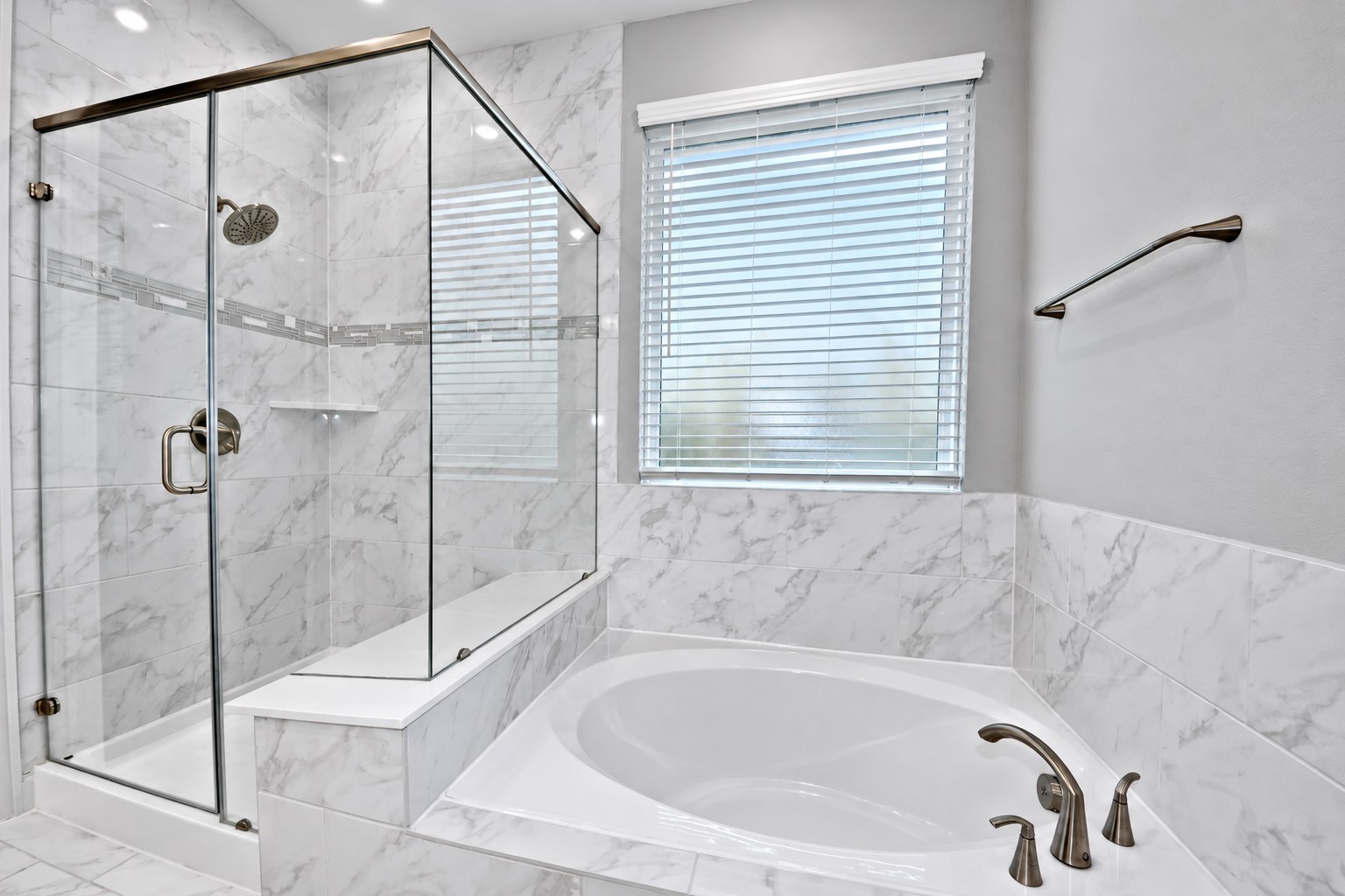 This Primary Suite Bathroom was design for Two! I am a Tub Person and I MUST have a deep Soaker Tub to Melt all that Stress from my day! Beautiful Tile Surroundings, Upgraded Frosted Window that allows that Natural Lighting in! Also included all the Upgraded Hardware and Towel Hangers!