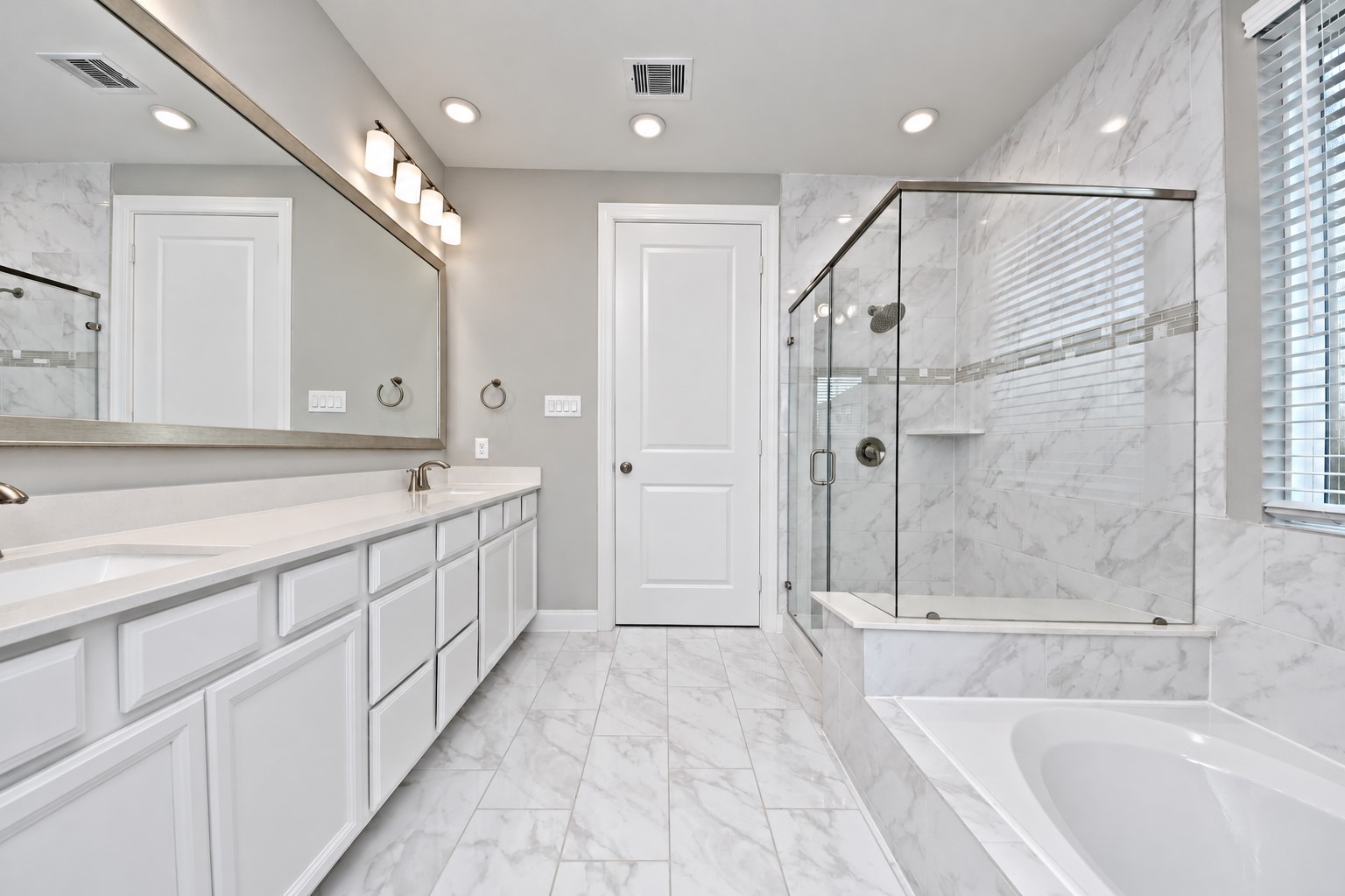 This Primary Suite Bathroom has it all! Huge Seamless Shower with Upgraded Tile and Splash of Custom Insert for that amazing statement! Walk In Shower has huge Sitting Bench for those Shower People to enjoy that Large Shower to start that day!