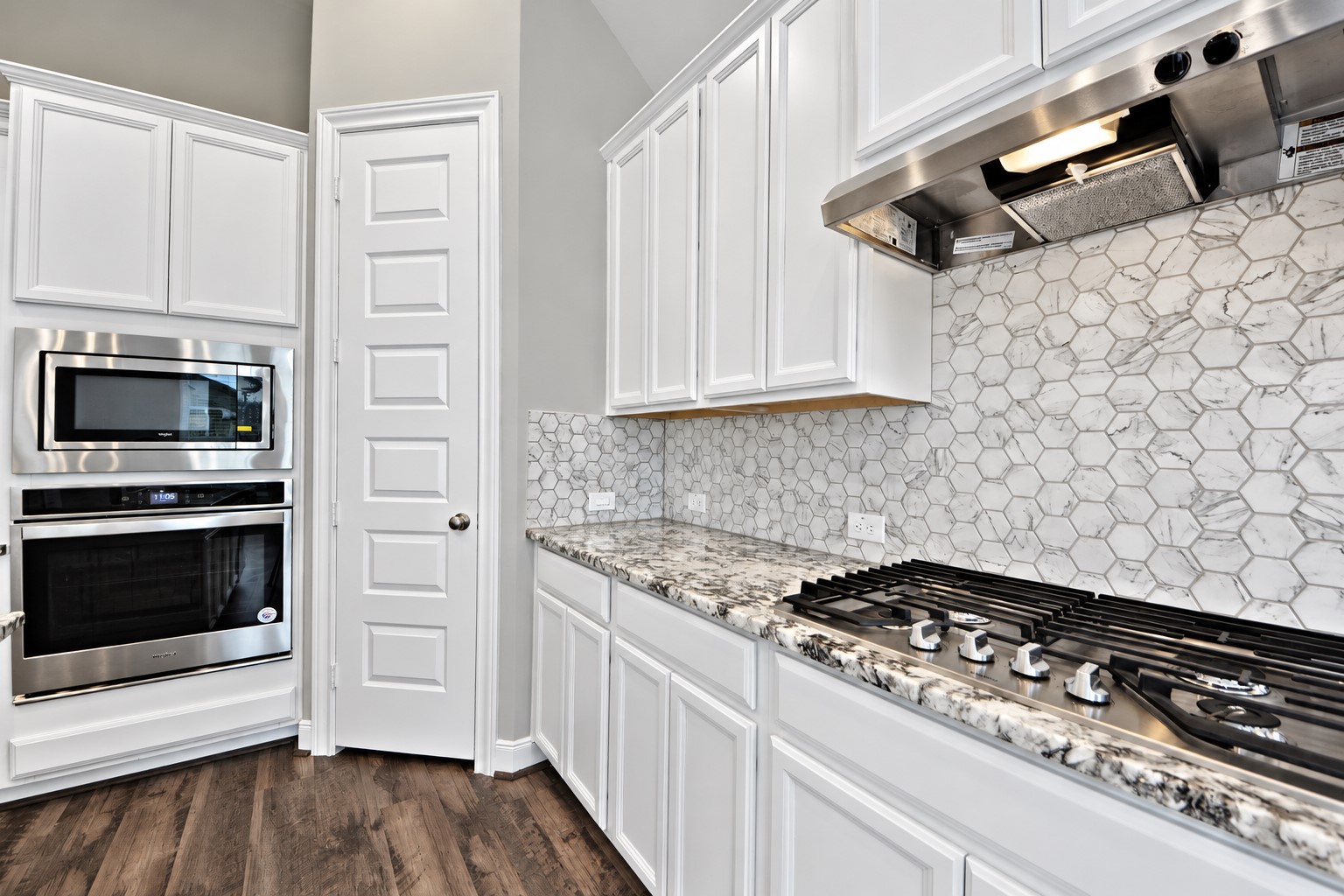 Beautiful Upgraded Granite Counters! Stunning Upgraded Tall White Cabinets with Marble Mosaic Tile Back-Splash! Built In Stainless Steel Gas Range for all your cooking needs! Built In Oven and Microwave Oven!