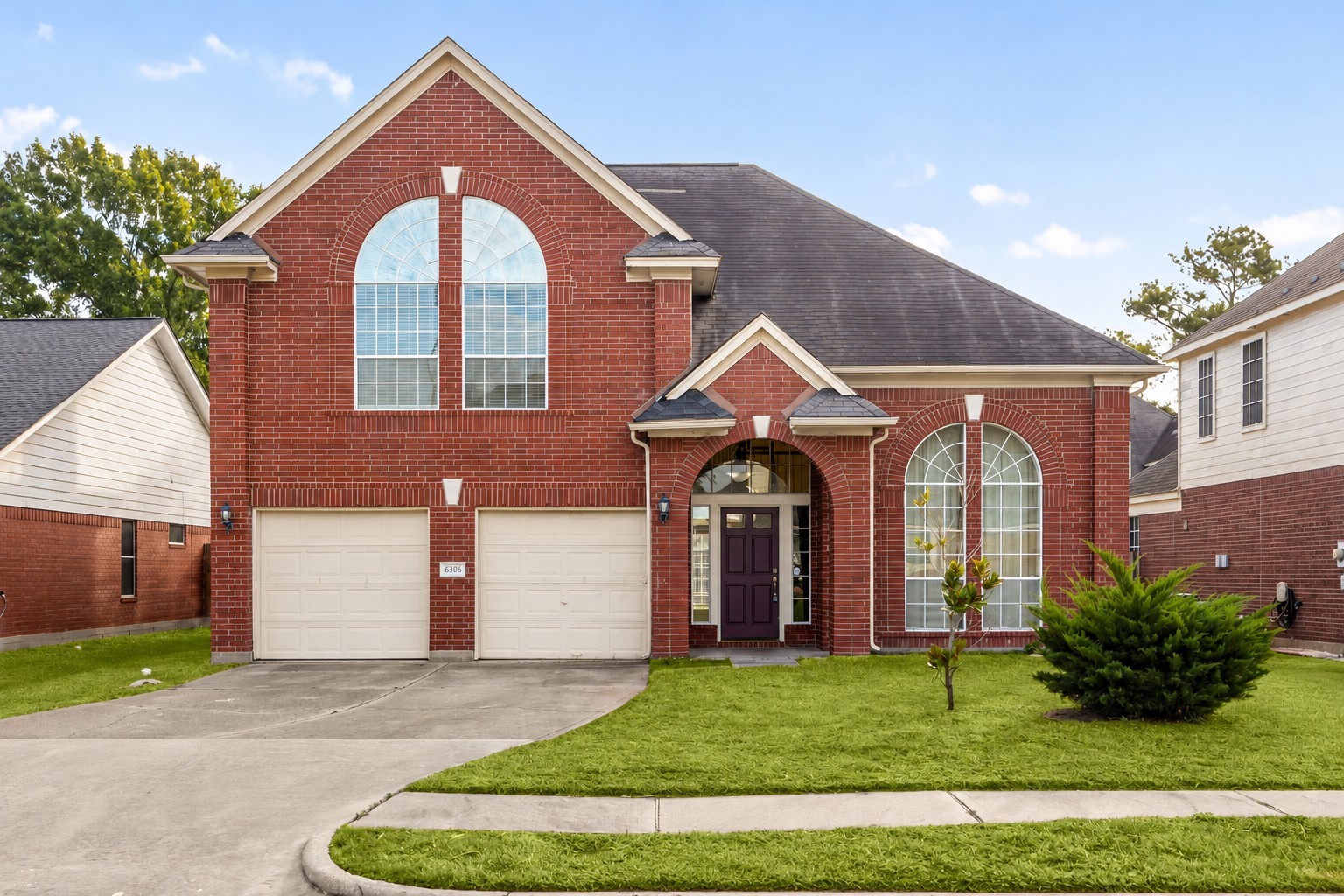 Welcome to 6306 Pago Lane, a stunning two-story home in the desirable Concord Bridge North community, offering elegant curb appeal with classic brick elevation and arched window details.