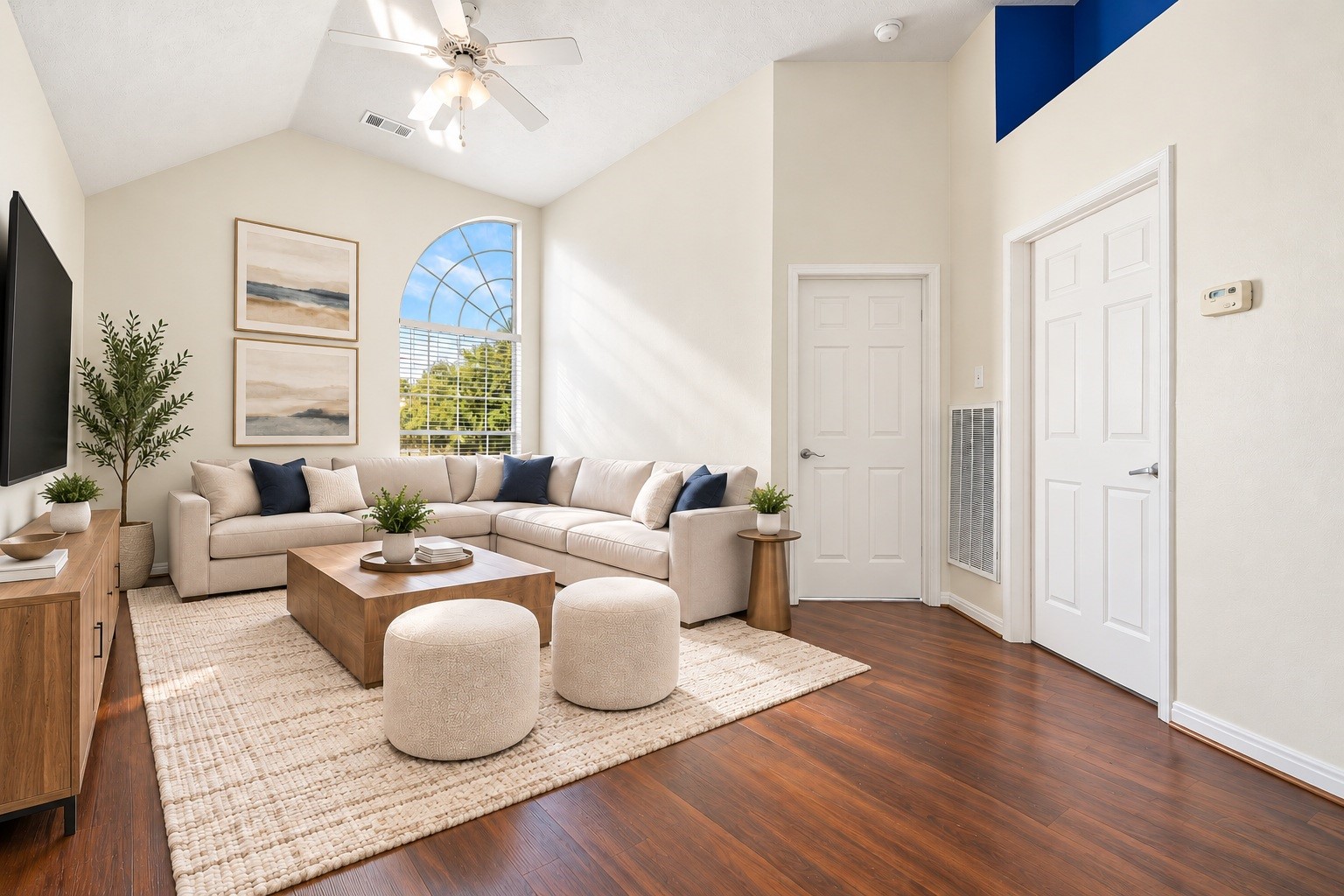 Upstairs, the spacious game room offers a dramatic arched window and vaulted ceiling, ideal for a media space, playroom, or second living area. Virtually staged.