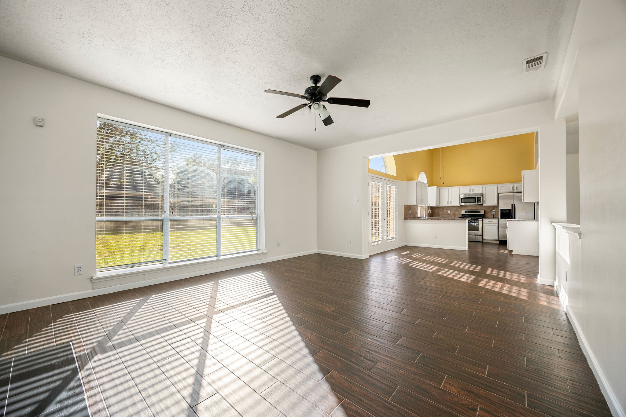 The open-concept layout flows effortlessly from the living area into the kitchen, perfect for everyday living and entertaining.