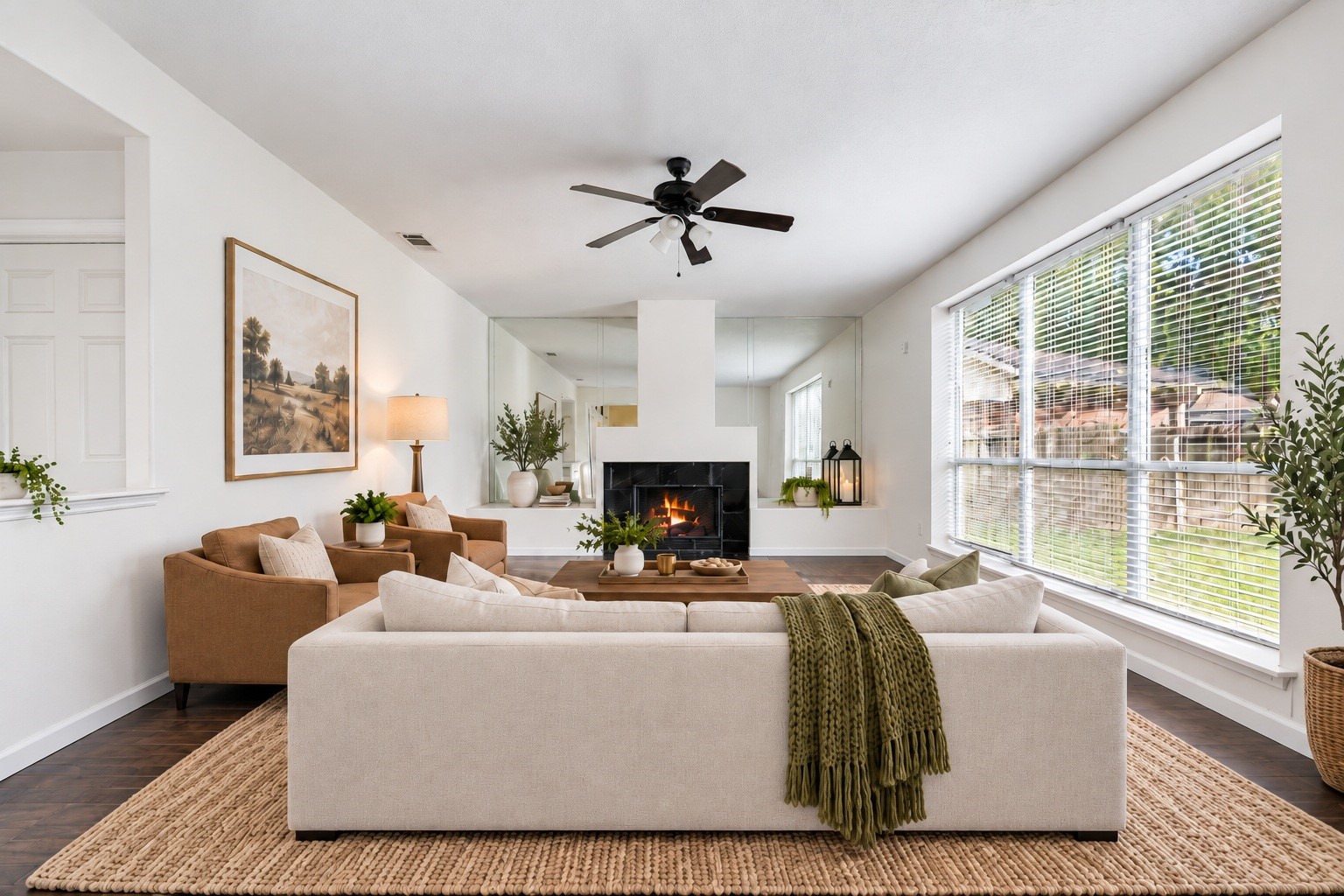 The living area offers a cozy fireplace and an abundance of natural light, creating a warm and inviting space to relax. Virtually staged.
