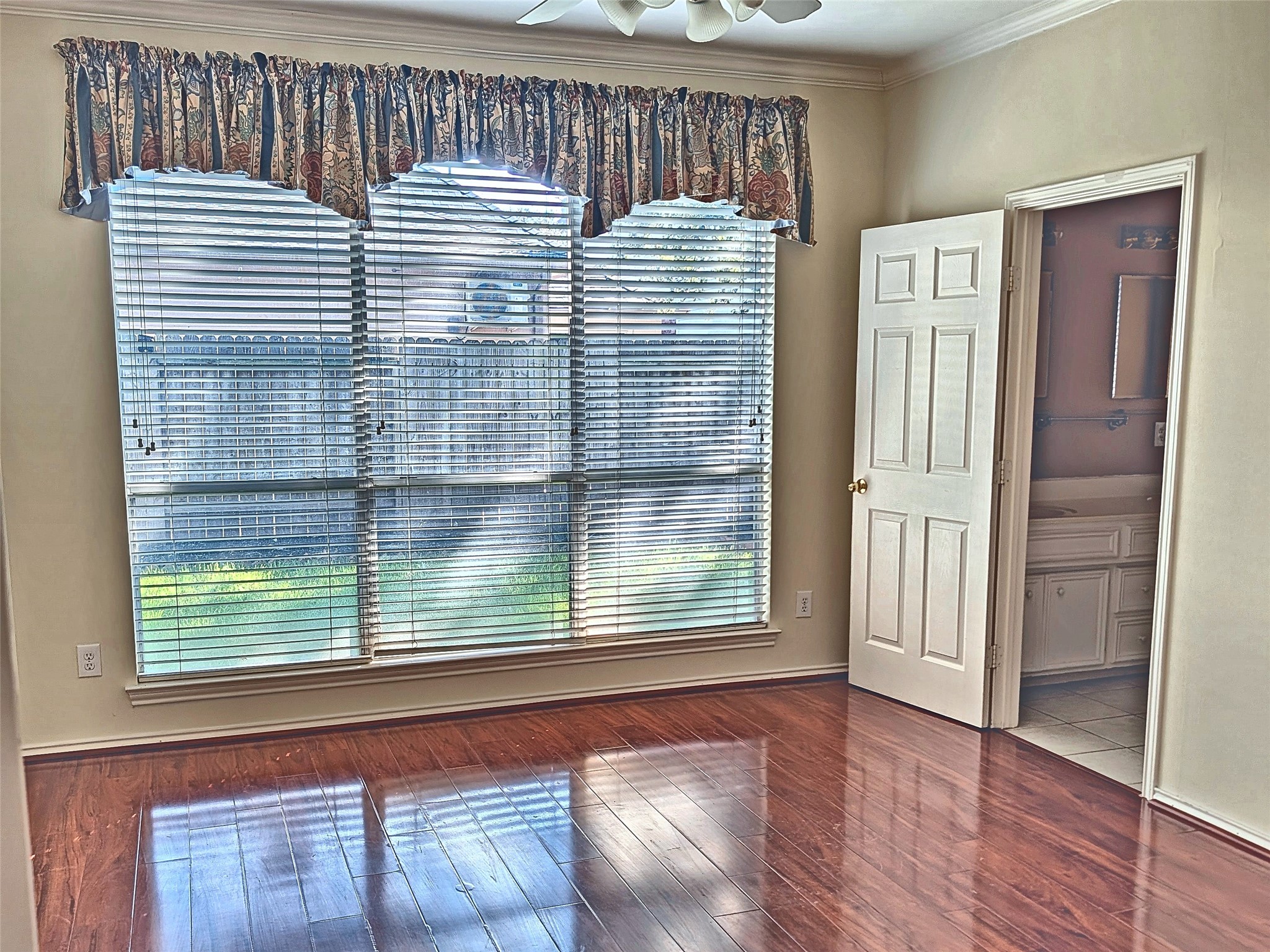 Downstairs primary bedroom retreat with bay windows and wood floors. Downstairs primary bedroom retreat with bay windows and wood floors.