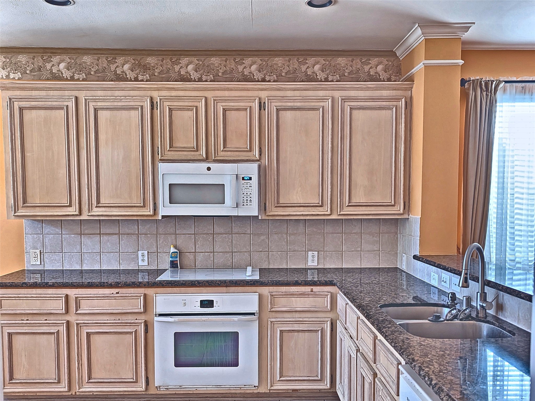 Functional kitchen with abundant cabinetry, tile floors, and clean appliances. Functional kitchen with abundant cabinetry, tile floors, and clean appliances.