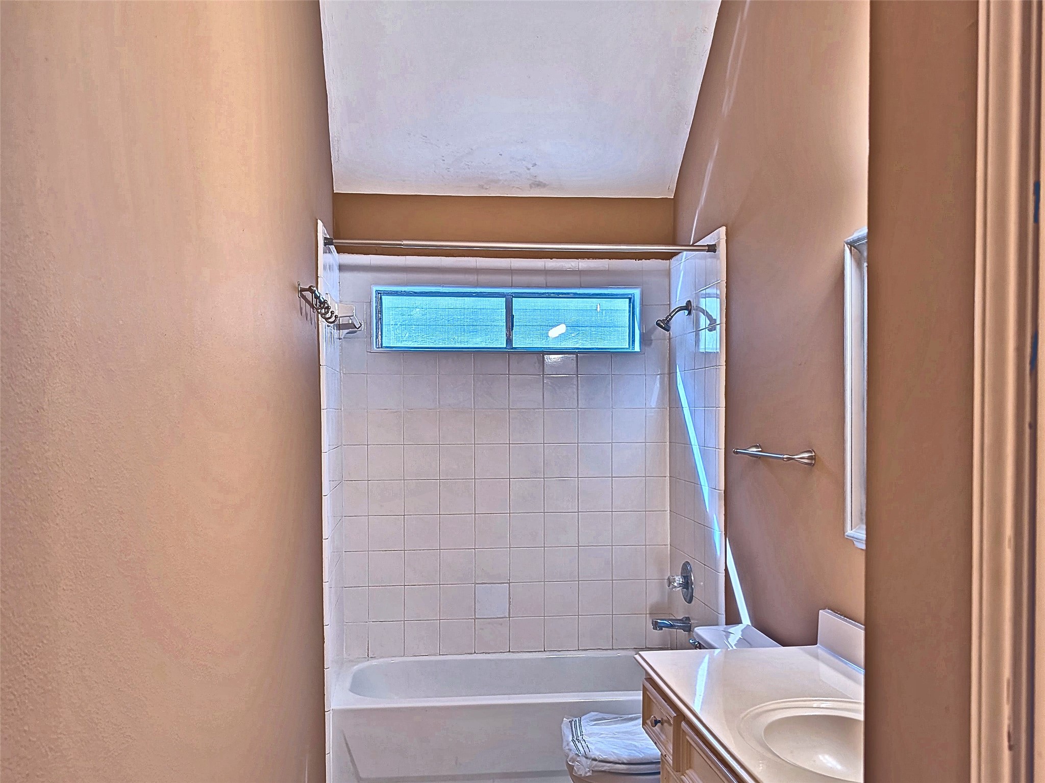 Second-floor full bathroom with extended vanity and tub/shower combo.