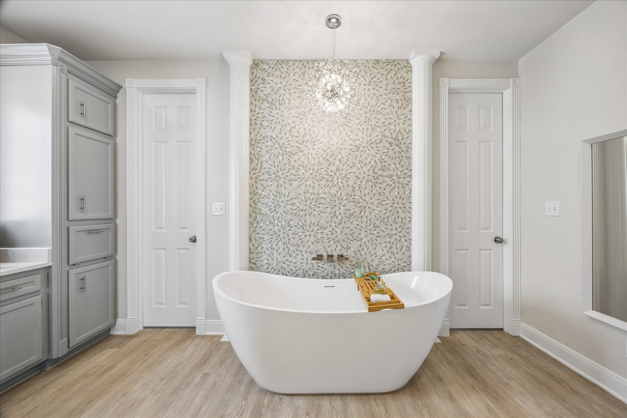 Another view of the elegant soaking tub, highlighted by the custom tiled accent wall and refined finishes that create a relaxing focal point in the completely remodeled primary bathroom.