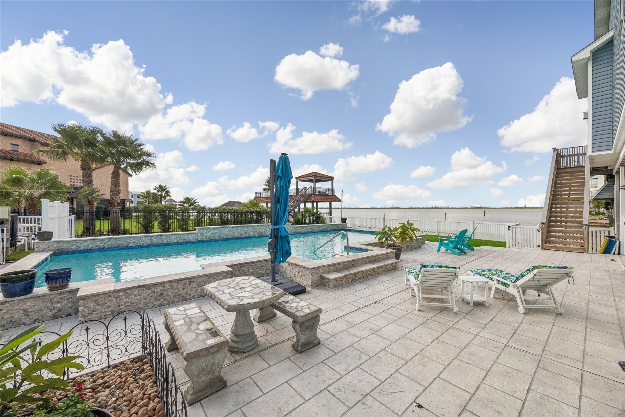 Impressive pool design and the surrounding outdoor space, with generous room for lounge seating, sunbathing, gatherings, and relaxing poolside.