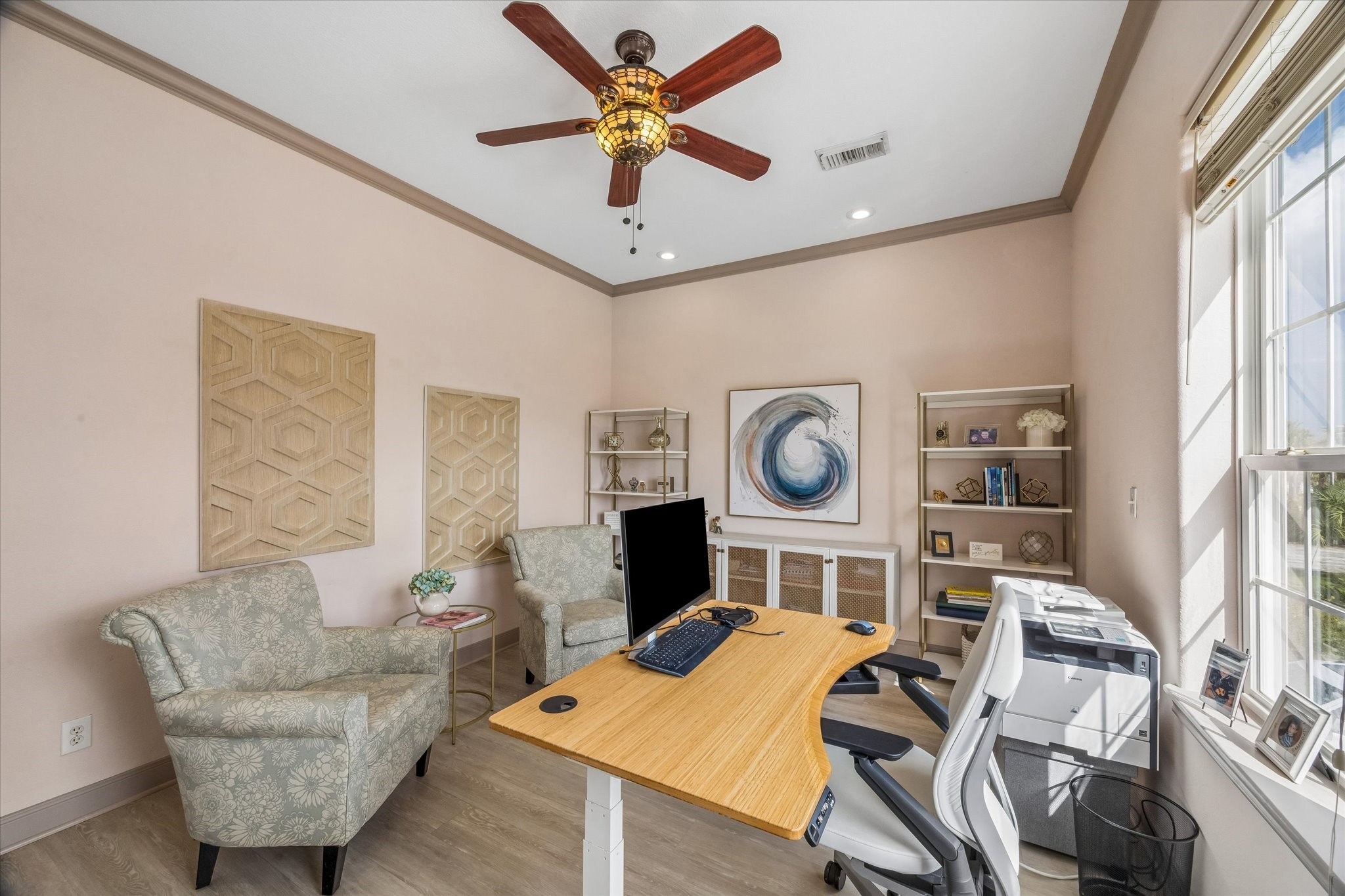 2nd level sizable bedroom currently used as an office, featuring vinyl wood flooring, a walk-in closet, and convenient access to the second-level full bath. Front-facing windows provide natural light and views toward the canal, adding a pleasant waterfront backdrop