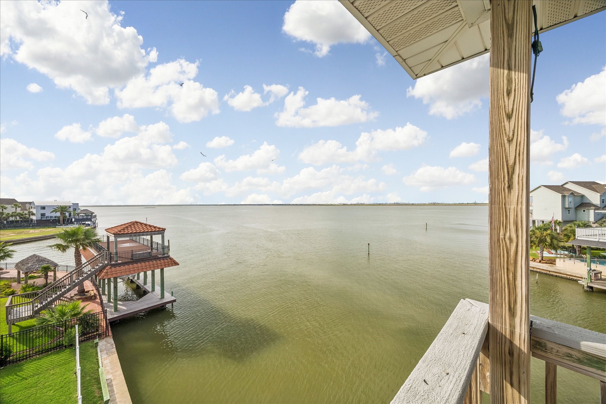 Enjoy sweeping Bay views from the third-level balcony, offering a relaxing outdoor retreat for unwinding, enjoying the coastal breeze, and taking in stunning waterfront sunsets. Look at those wide open views!