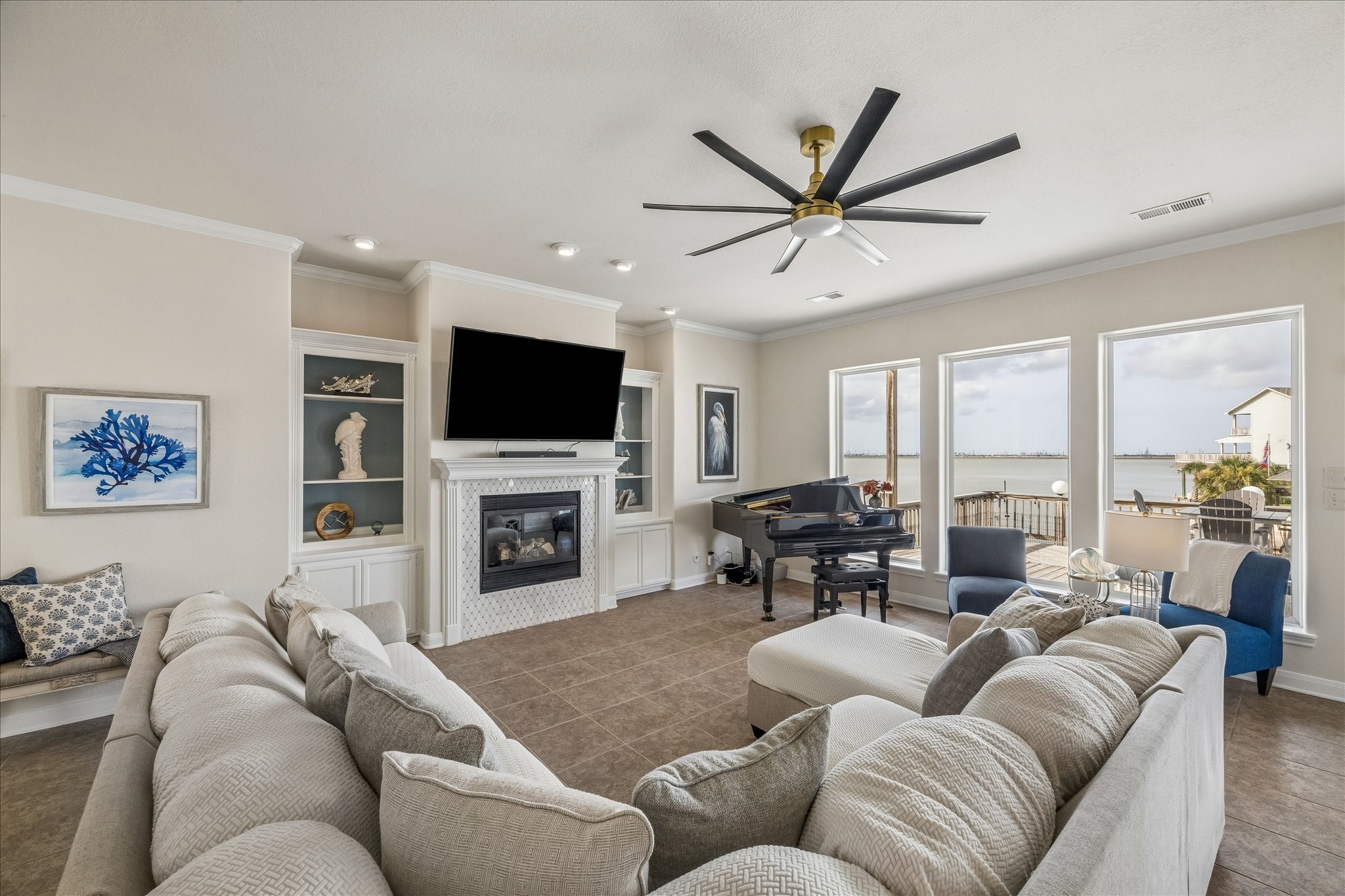 Spacious living area featuring a full wall of windows overlooking the Bay, filling the room with natural light and showcasing stunning waterfront views.