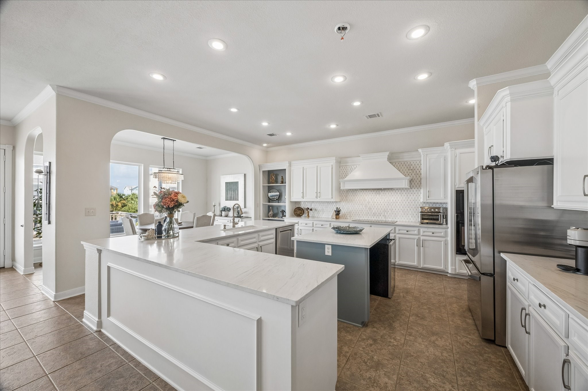 Kitchen showcases new quartz countertops, a spacious island with storage and breakfast bar seating, plus two sinksa full-size sink and a separate prep sink for added functionality.