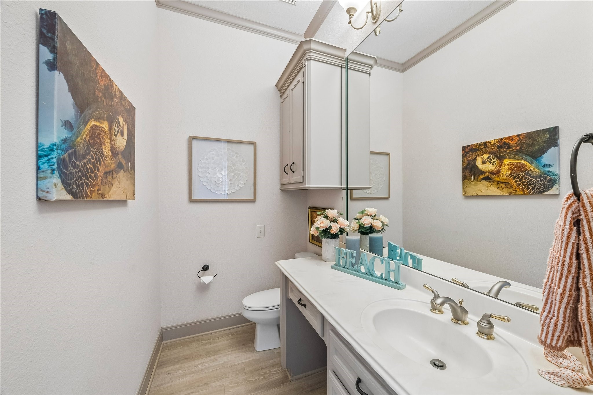 A convenient half bath is located just off the kitchen, living area & elevator.