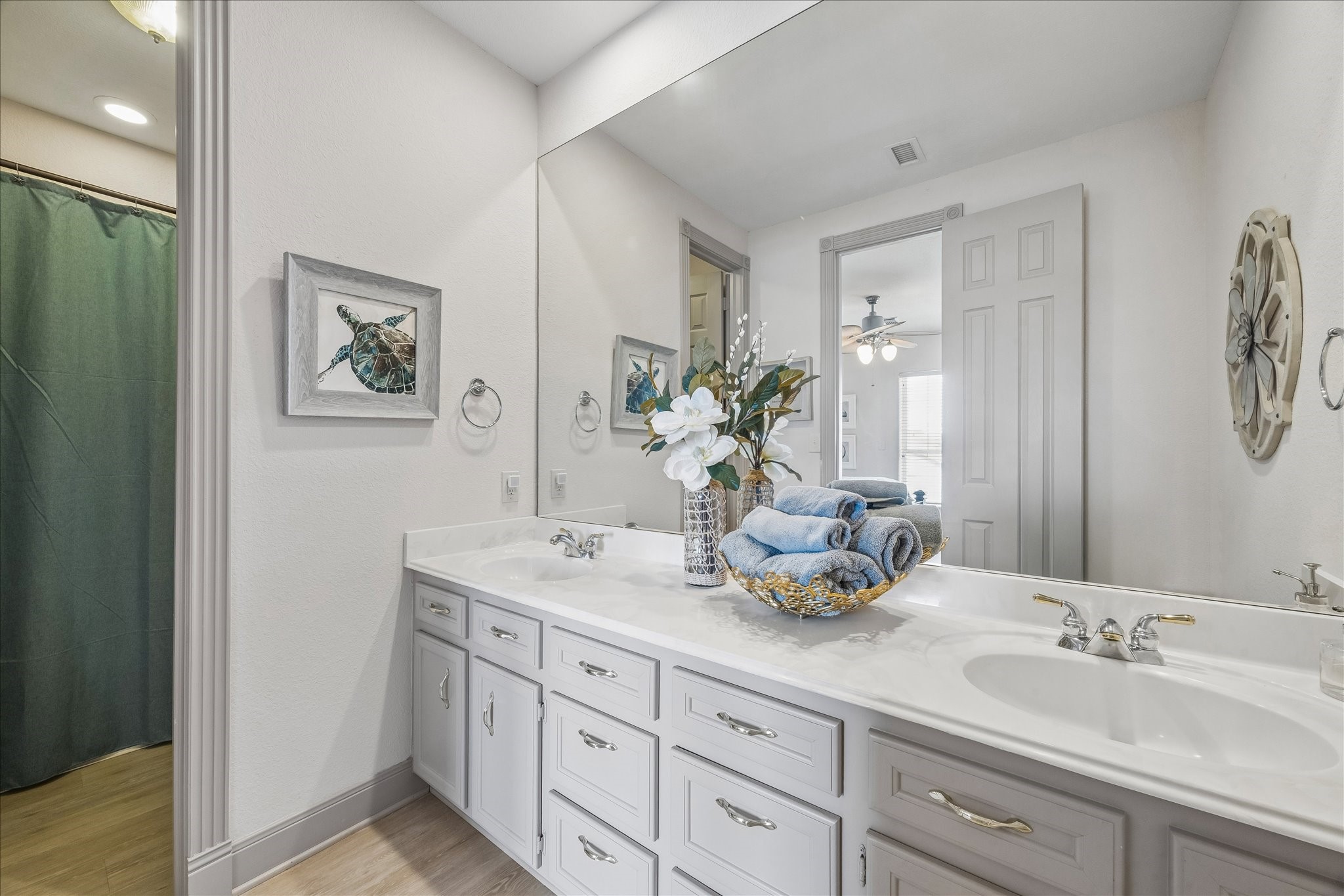 3rd level guest bathroom featuring a dual vanity with ample cabinet storage, providing plenty of space and functionality for family and guests.