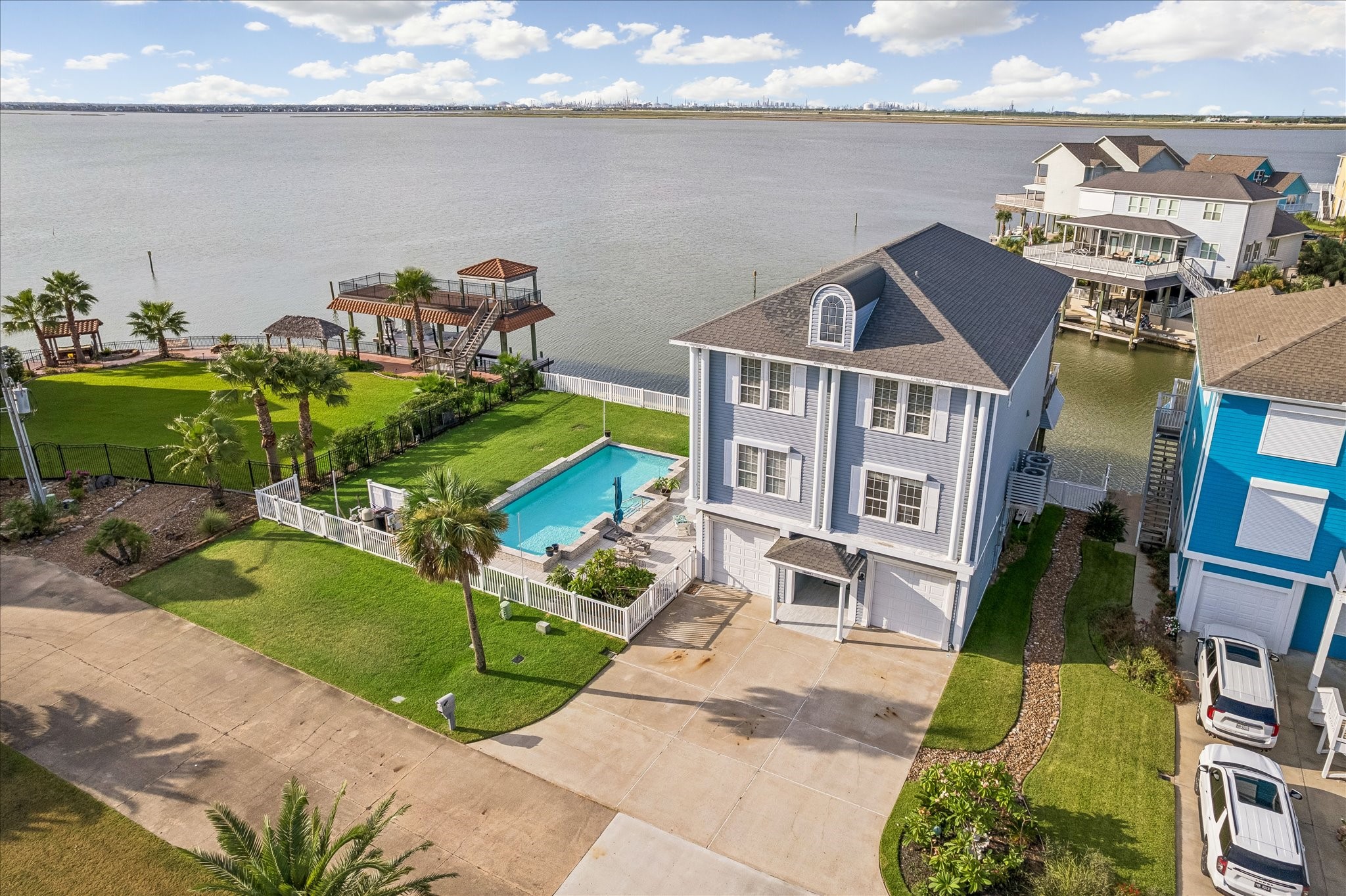 Welcome to 426 Sunset Circle at Tiki Island! BAYFRONT, DOUBLE HOMESITE OVERLOOKING JONES BAY WITH A POOL & MASSIVE YARD, featuring stunning coastal architecture, breathtaking bay views, large balconies, double boathouse, and exceptional outdoor living..This is where you want to be!
