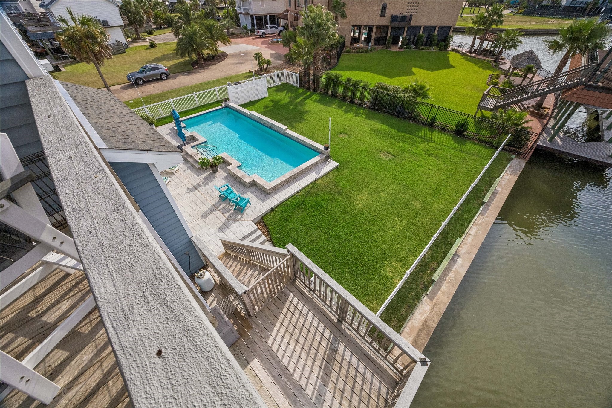 Take a look at your massive yard and pool, complete with a beautiful waterfall feature and fully fenced groundsan inviting setting for relaxing, entertaining, and enjoying an amazing waterfront lifestyle!