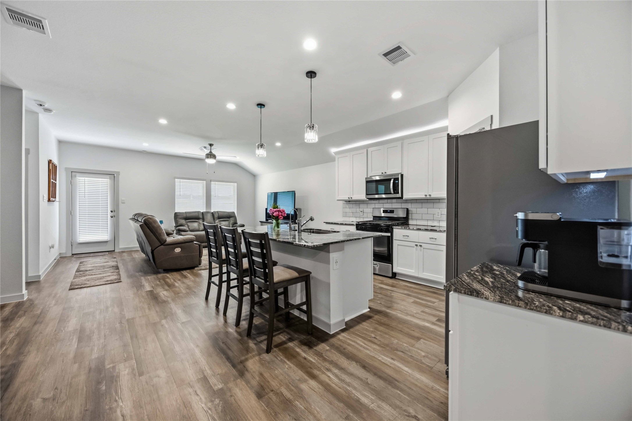 This is an open concept home - offering updated pendant lighting over the bar.