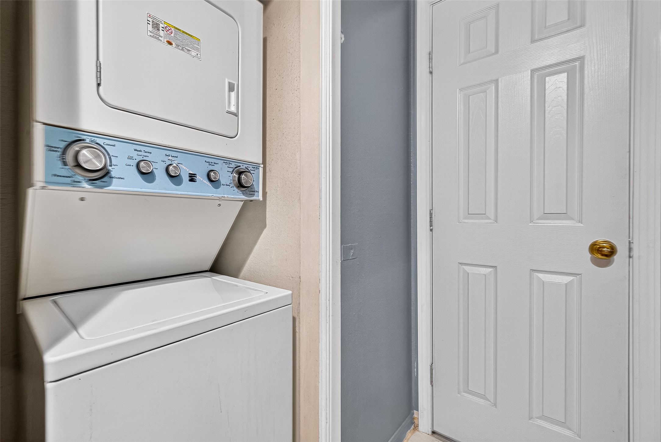Stacked up washer and dryer connection in the bathroom.