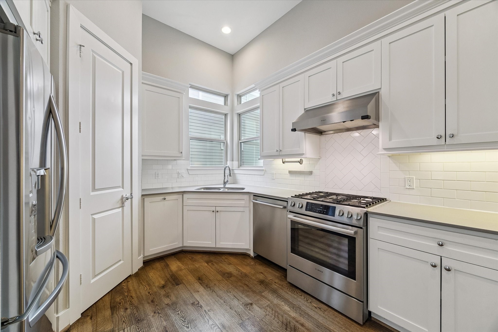 Beautiful, modern kitchen with stainless steel appliances and gas range.