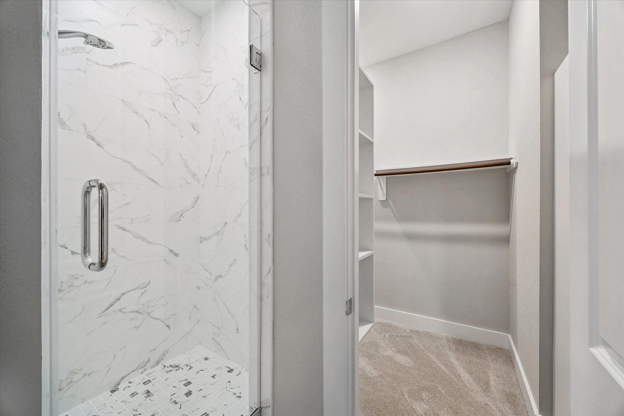 Primary bathroom and a view of the oversized closet.