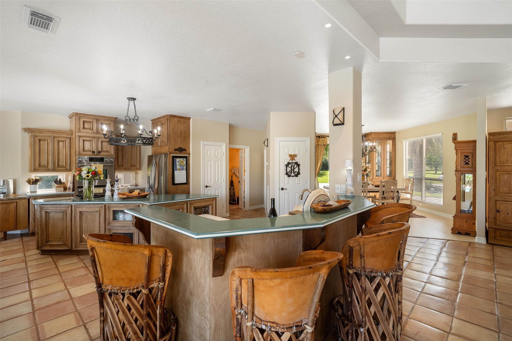 Beautiful kitchen with custom cabinets, grand island and bar top seating area