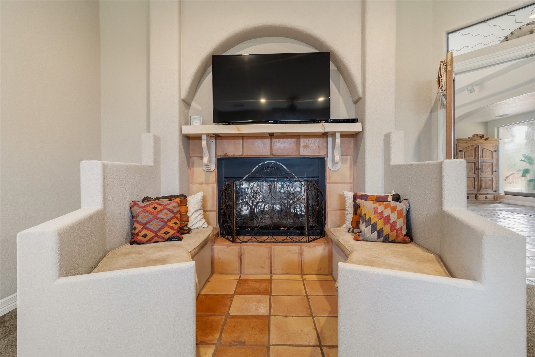 Adorable seating area around the cozy fireplace in the primary bedroom