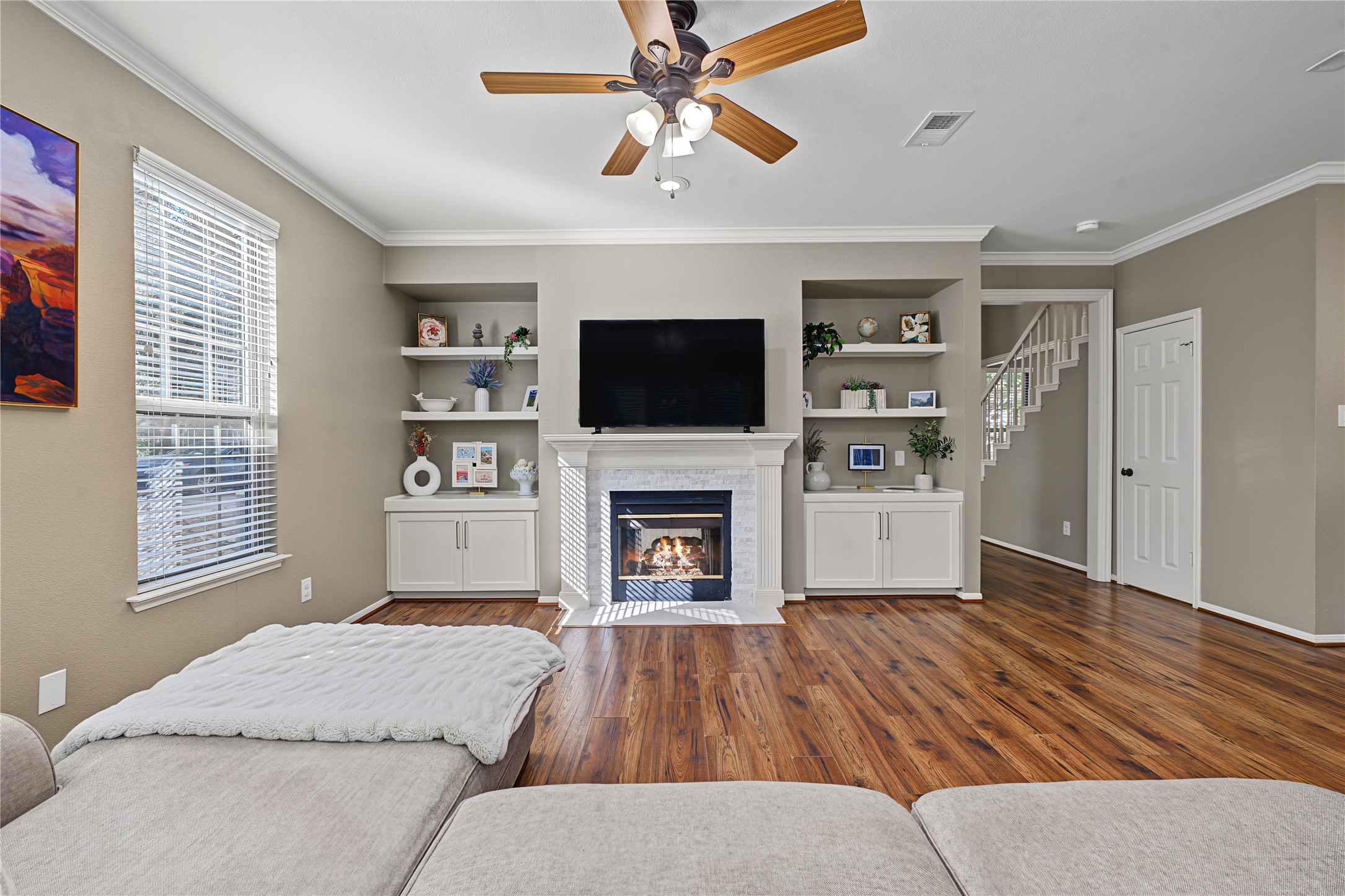 Take note of the custom built-in shelving and storage solutions, both functional and beautiful.