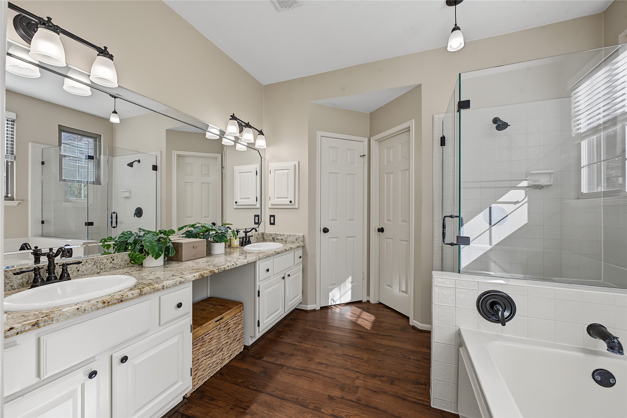 Primary bathroom featuring a spacious soaking tub and a separate walk-in shower.