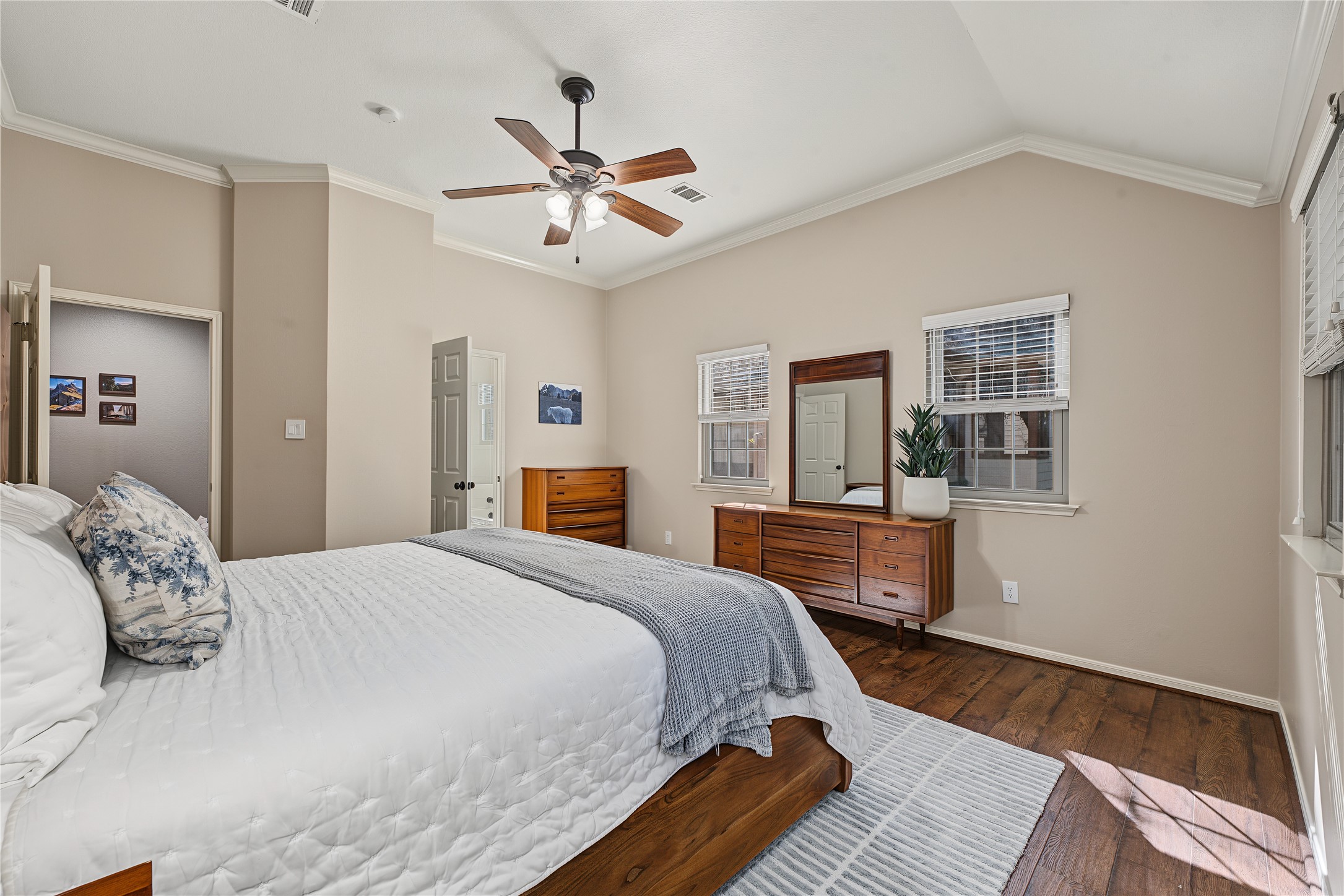 Fresh neutral paint and elegant crown moulding offer a warm elegance that every primary suite deserves.