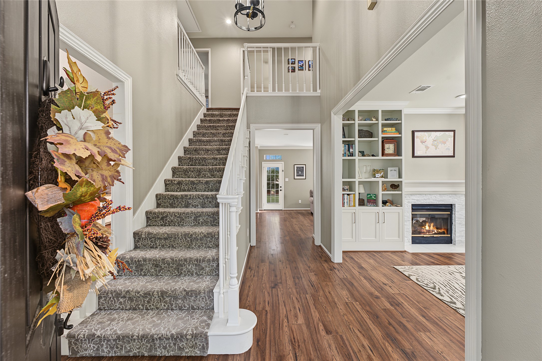 The bottom floor features two distinct living areas, a formal dining area, and kitchen.