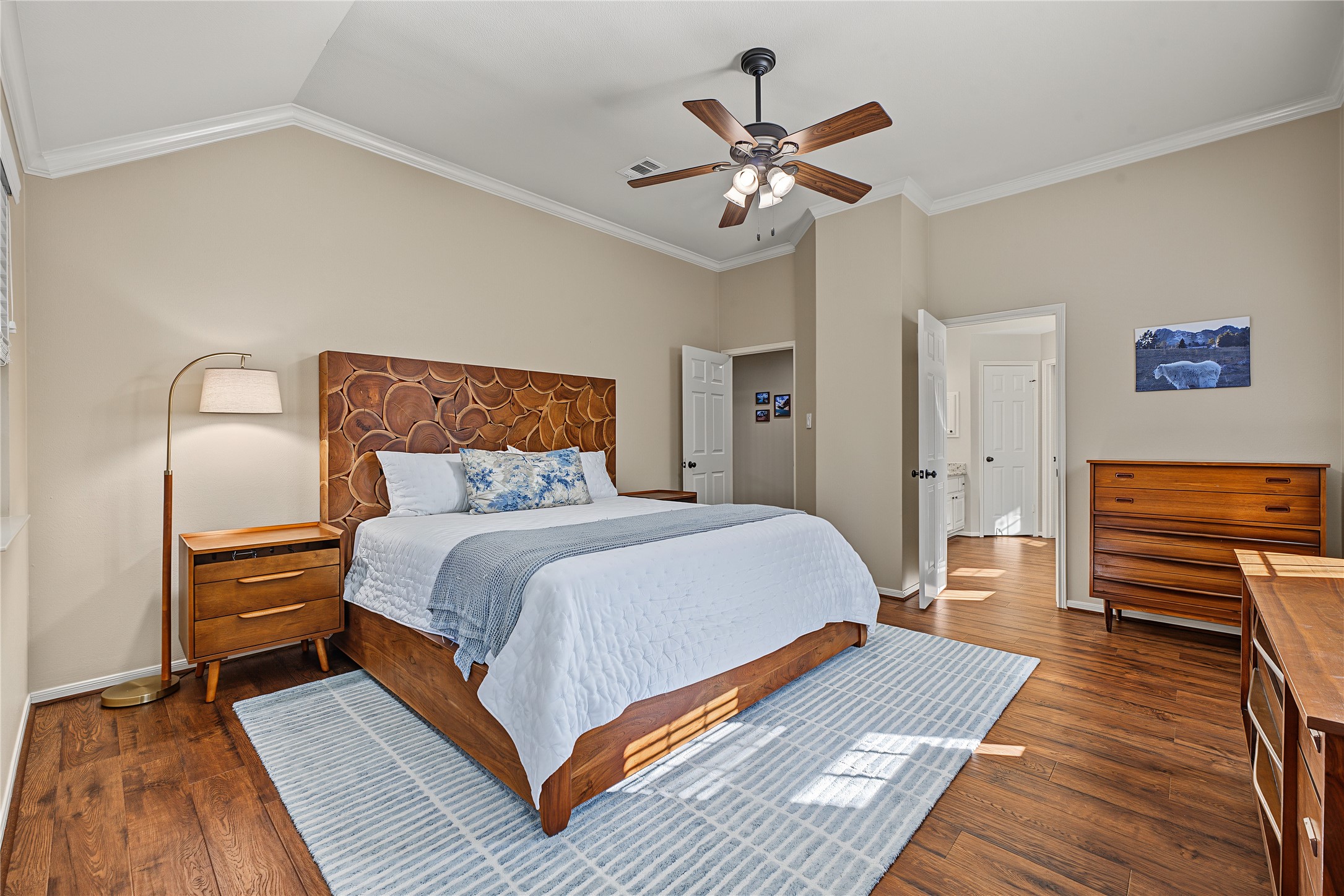 Spacious primary suite with high vaulted ceiling and updated flooring.