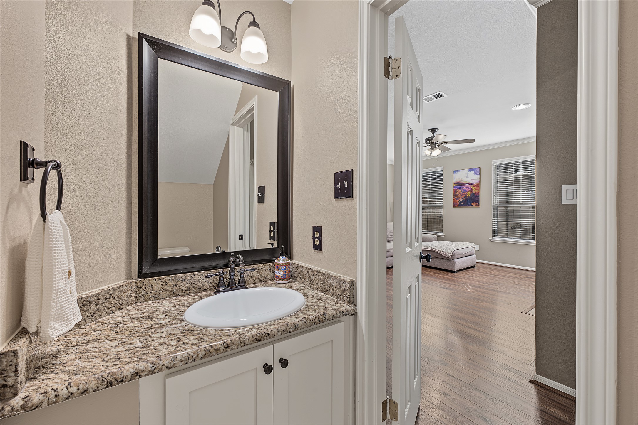 Half bath / powder room located conveniently under the stairs.