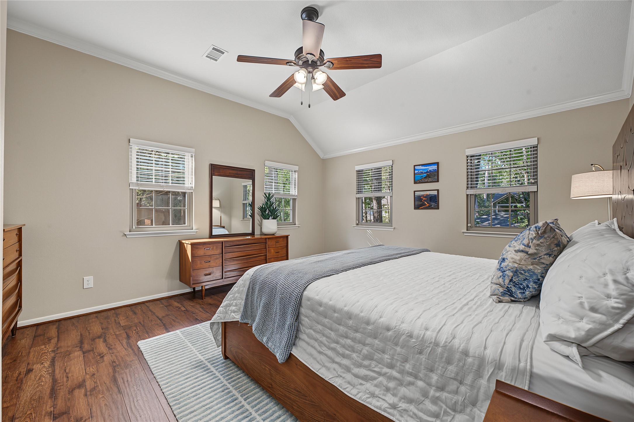 Alternate view of the primary suite shows an abundance of natural light.