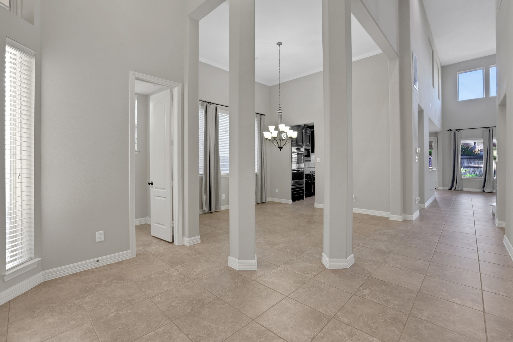 As you step into this gorgeous Trendmaker home you are greeted. by tile flooring and architectural details that make this home stand apart