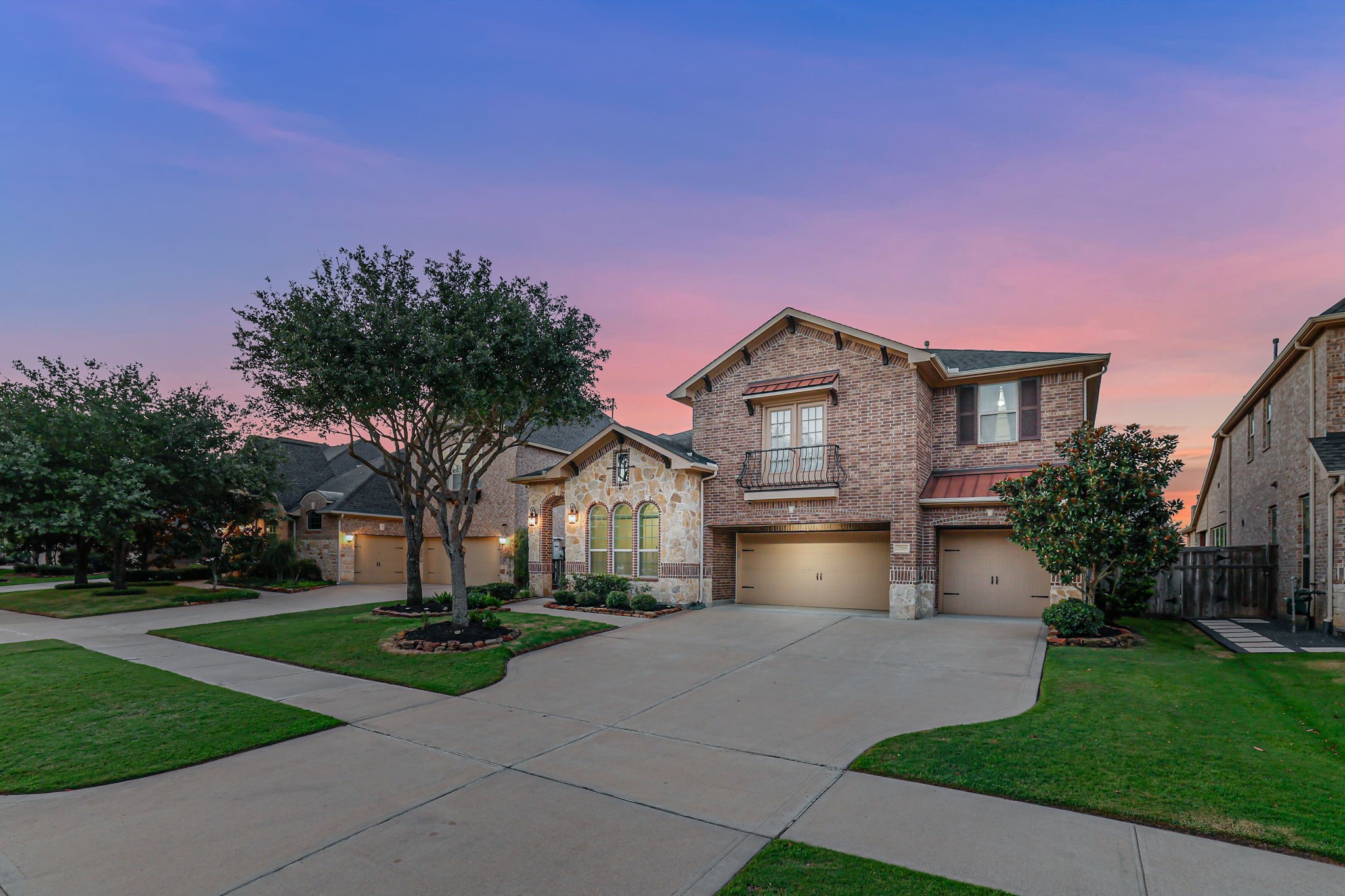 Elegant brick-and-stone exterior offering generous spacing from neighbors and a spacious 3-car garage.