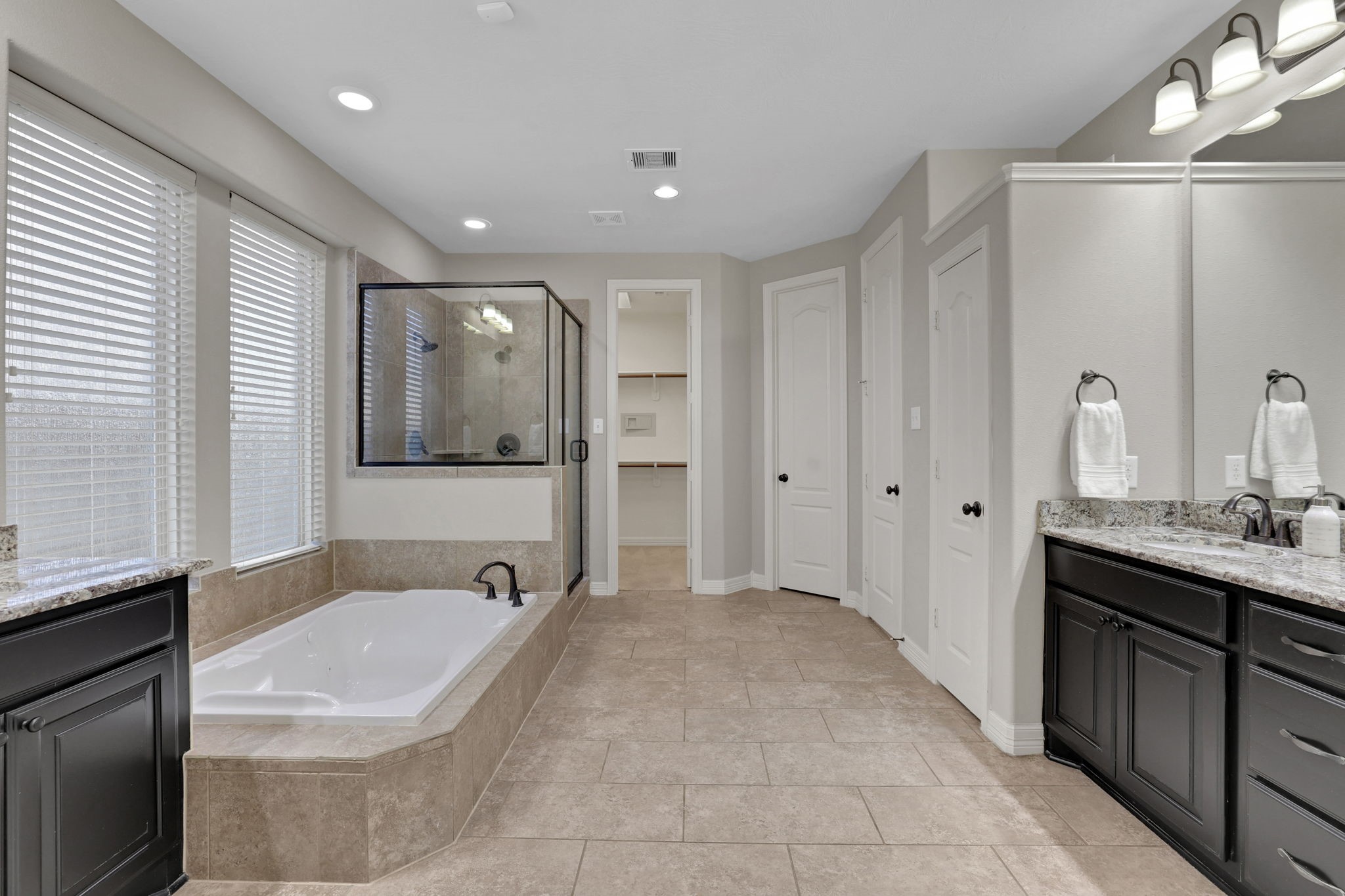 The primary bath features a soaking tub and separate shower