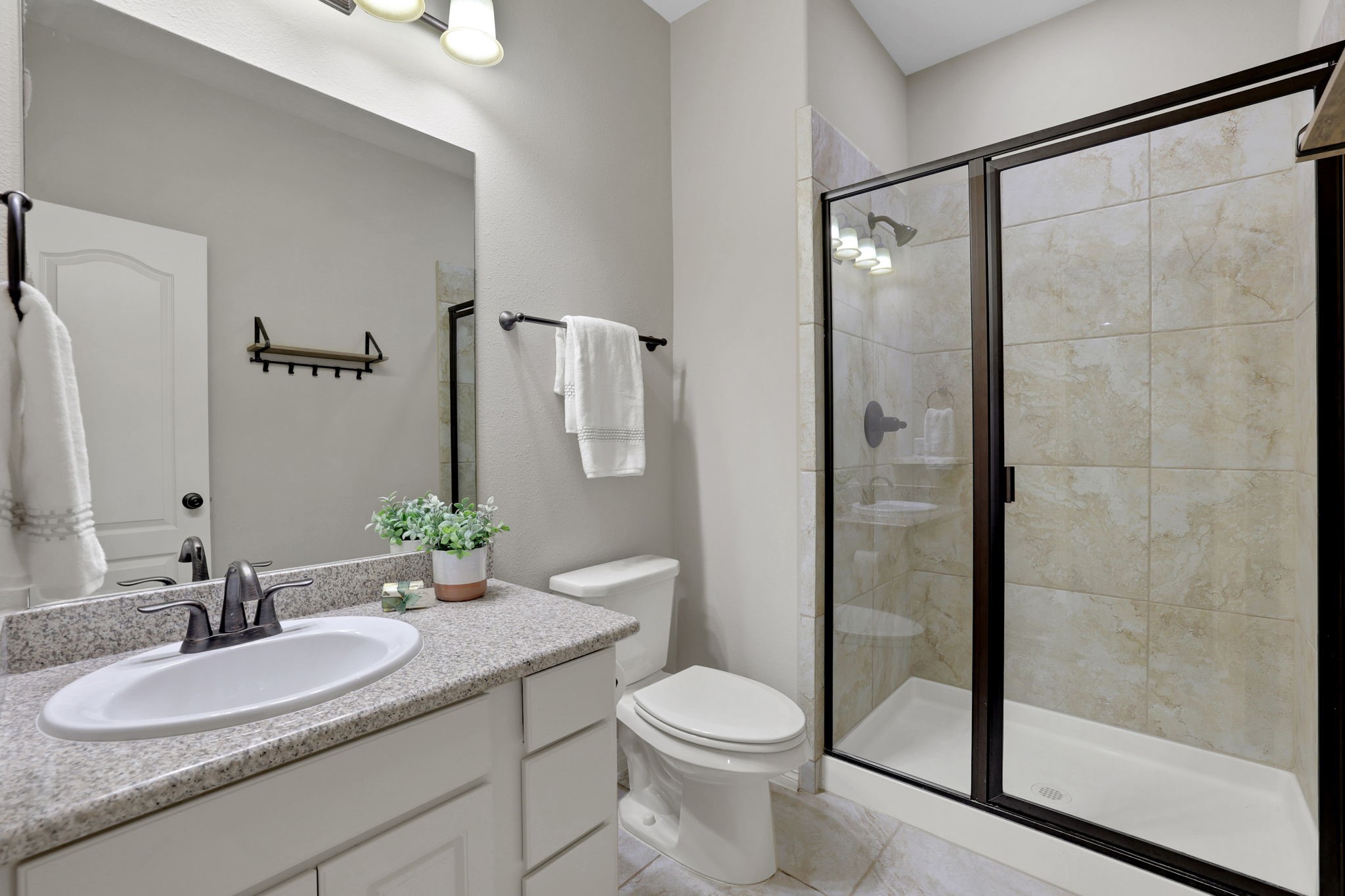 Another secondary bathroom upstairs with a standing shower