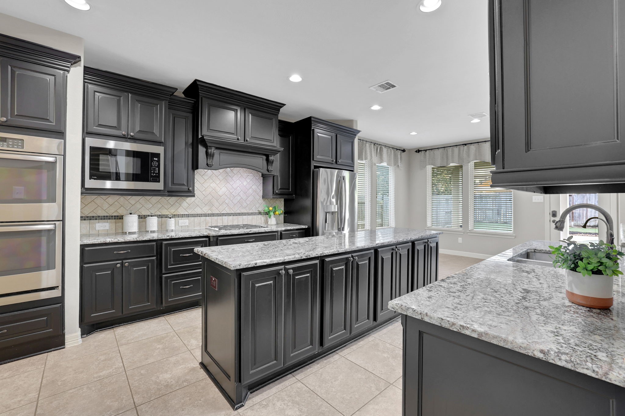 The kitchen cabinets are freshly painted and in pristine condition.