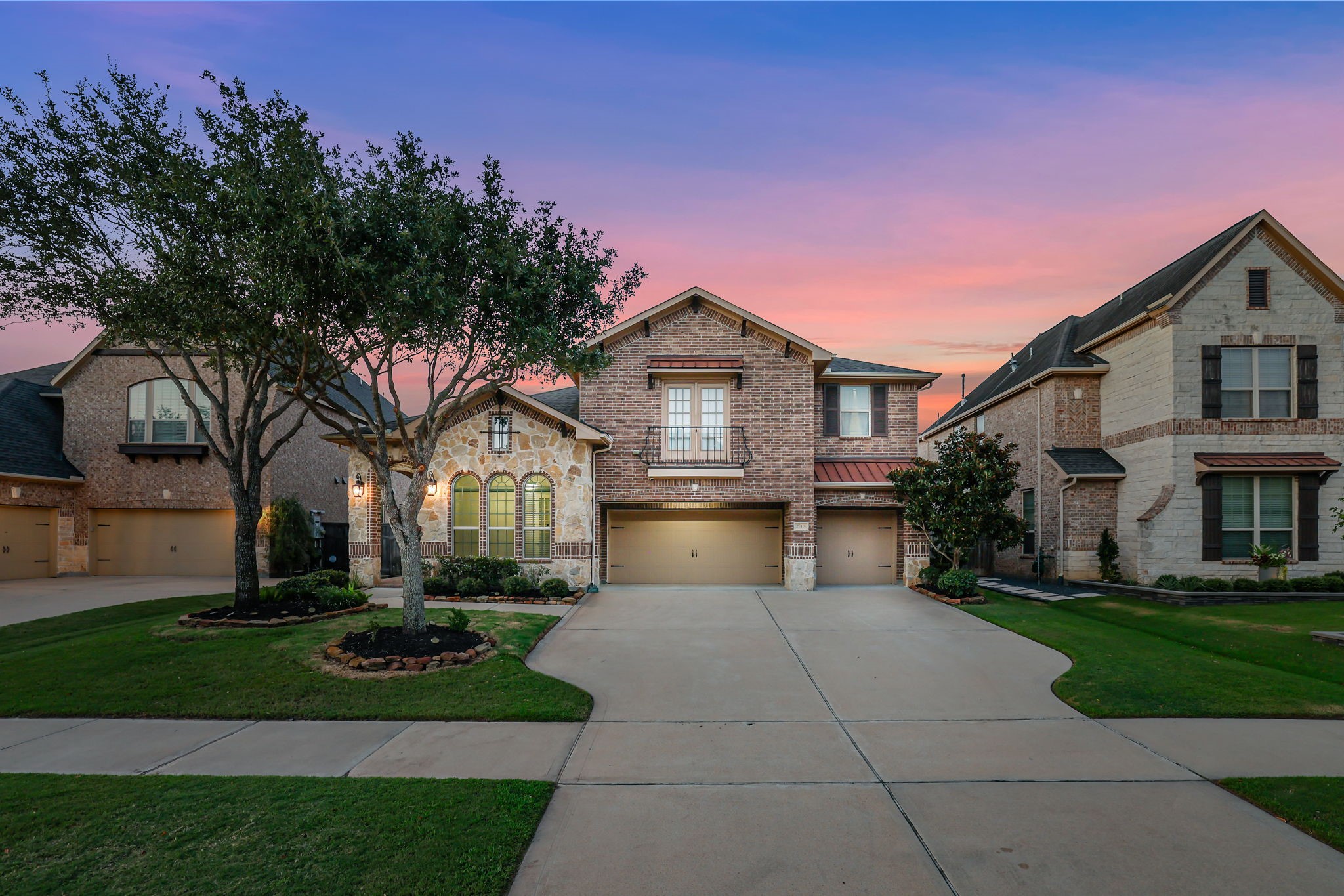 Stone and brick front elevation of this gorgeous Trendmaker Home with a 3-car garage!