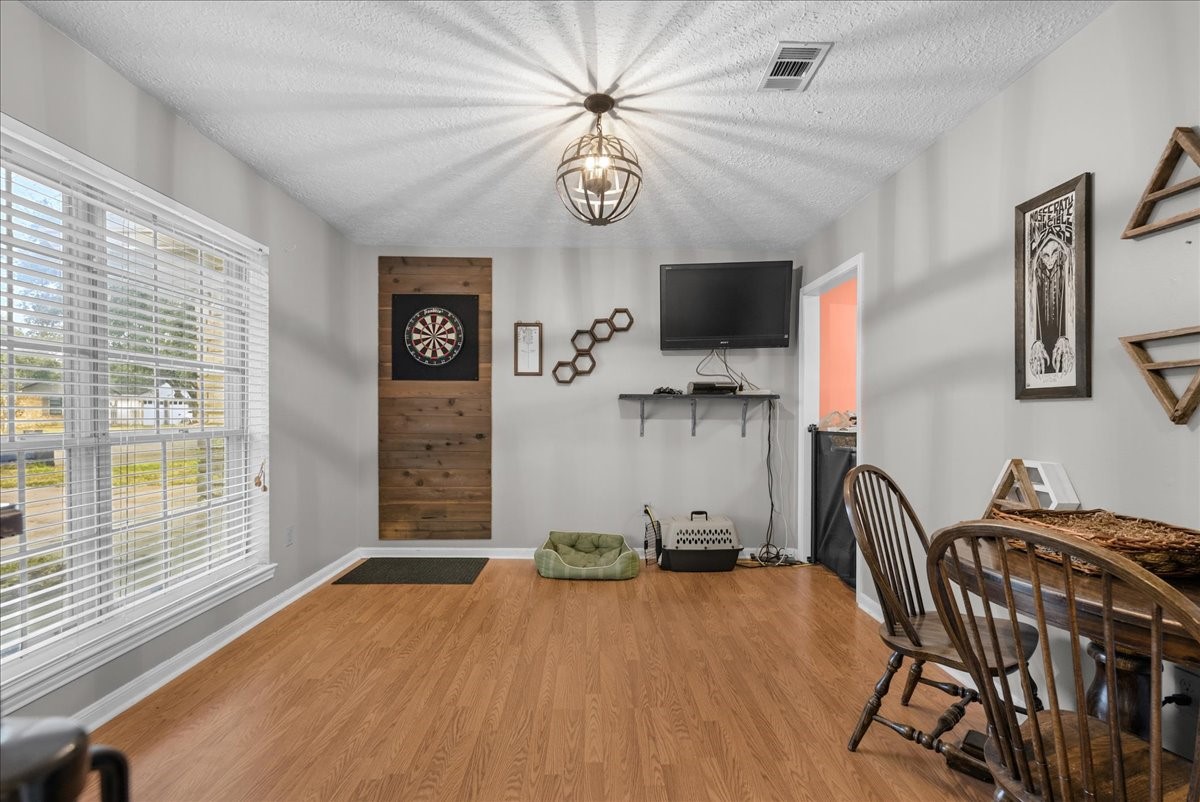 Additional dining area view featuring a large front-facing window and natural light.