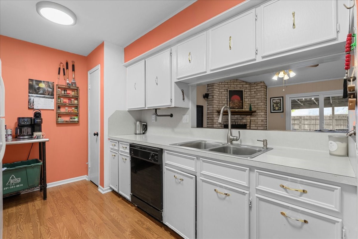 Kitchen features a double-basin sink, dishwasher, and pass-through overlooking the living room. Kitchen features a double-basin sink, dishwasher, and pass-through overlooking the living room.