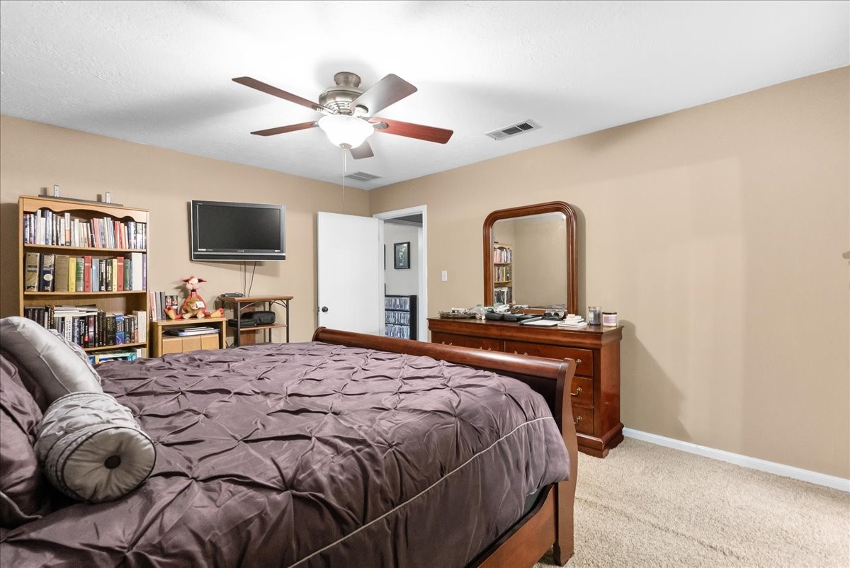 Additional primary bedroom view showing the room's size and furniture arrangement.