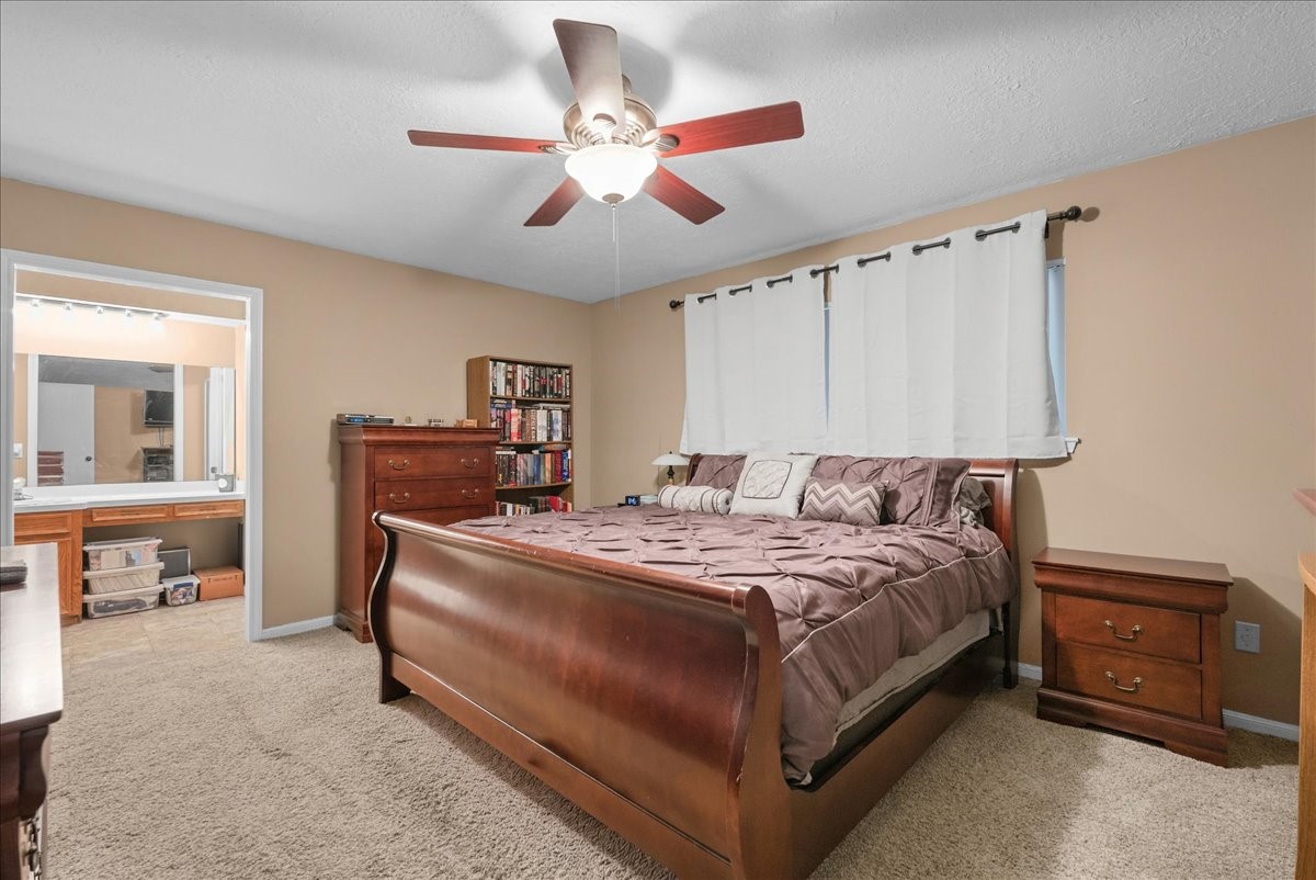 Primary bedroom offers generous space for furniture and convenient access to the ensuite bathroom.