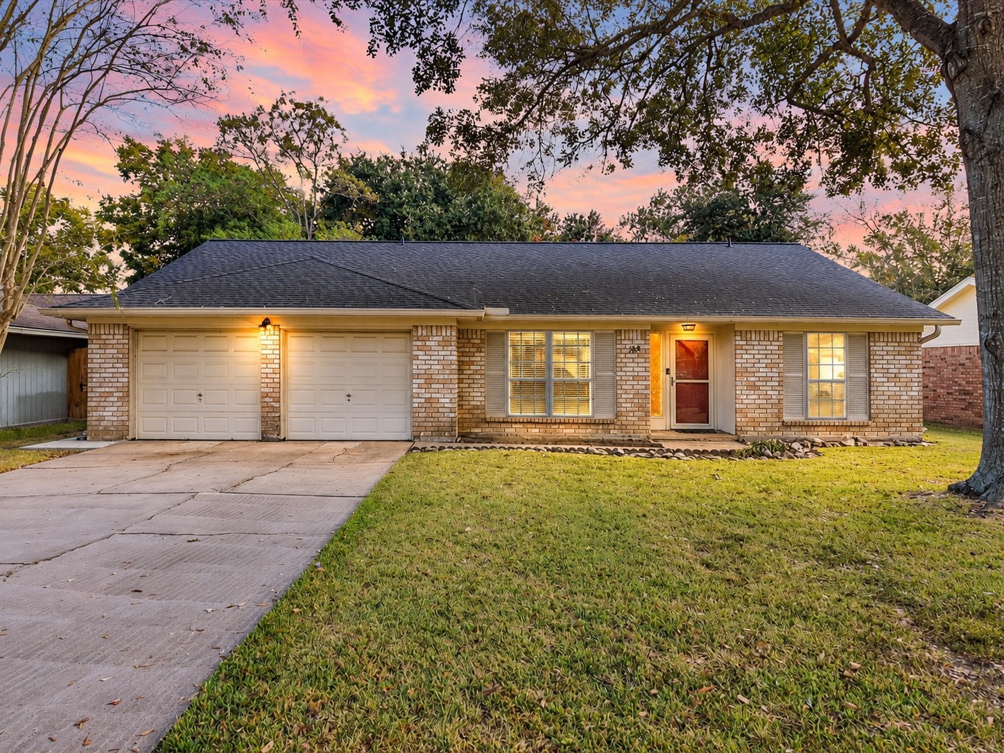 Twilight view highlighting the home's traditional brick exterior and welcoming evening appearance.
